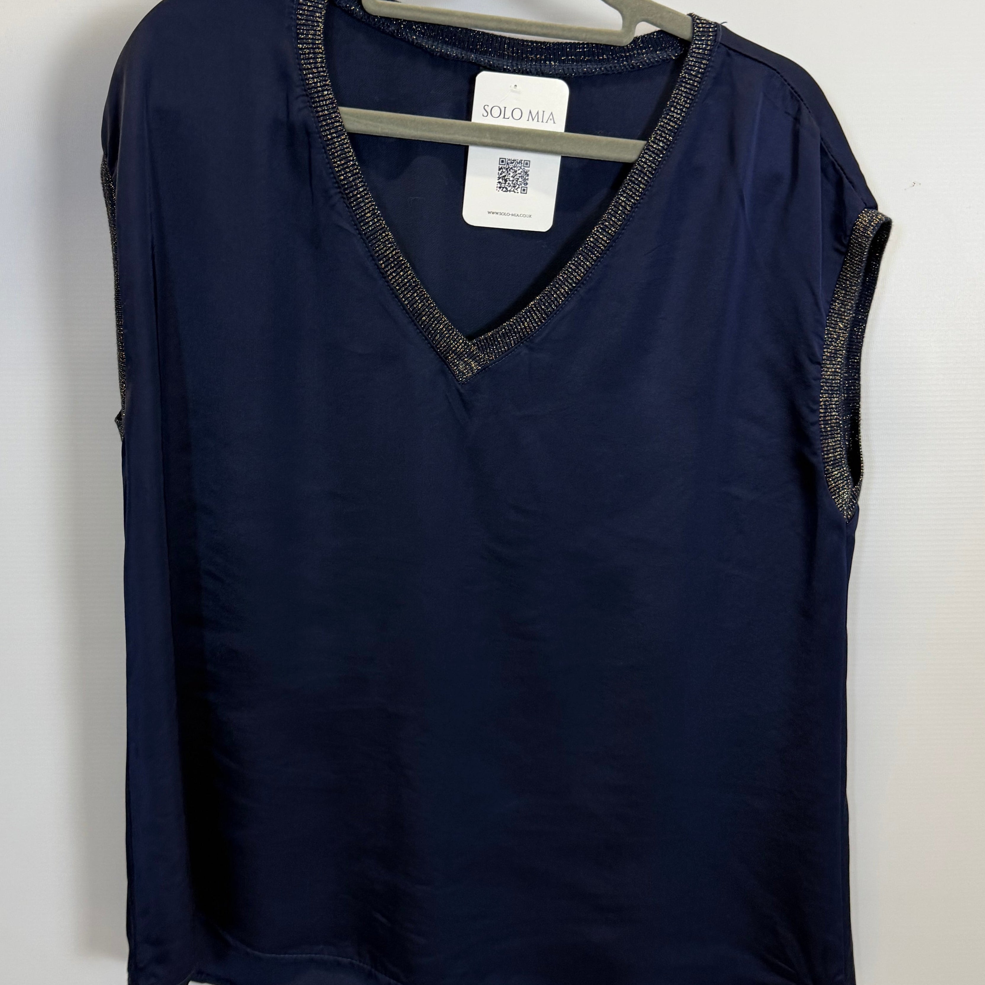 Folded navy blue garment with a tag on a white background