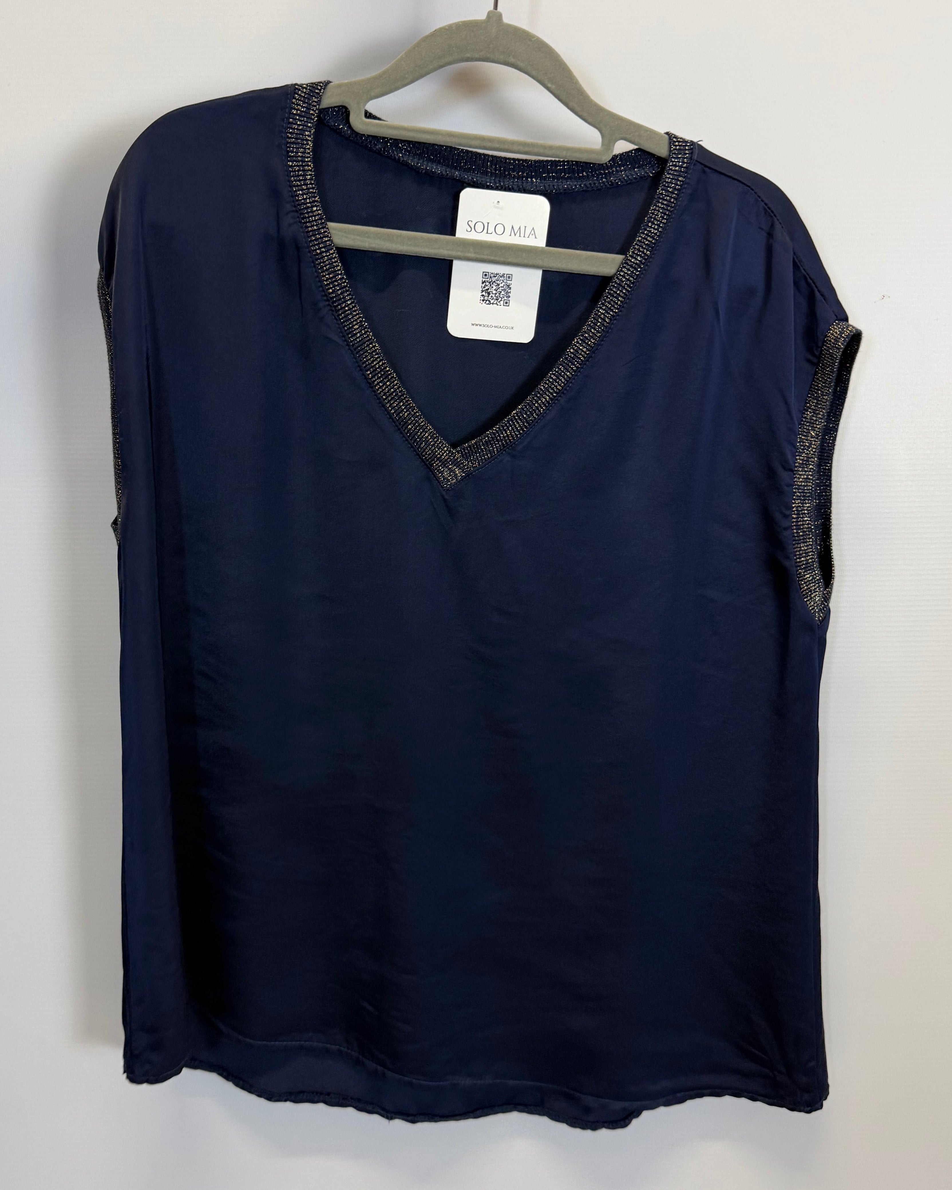 Folded navy blue garment with a tag on a white background