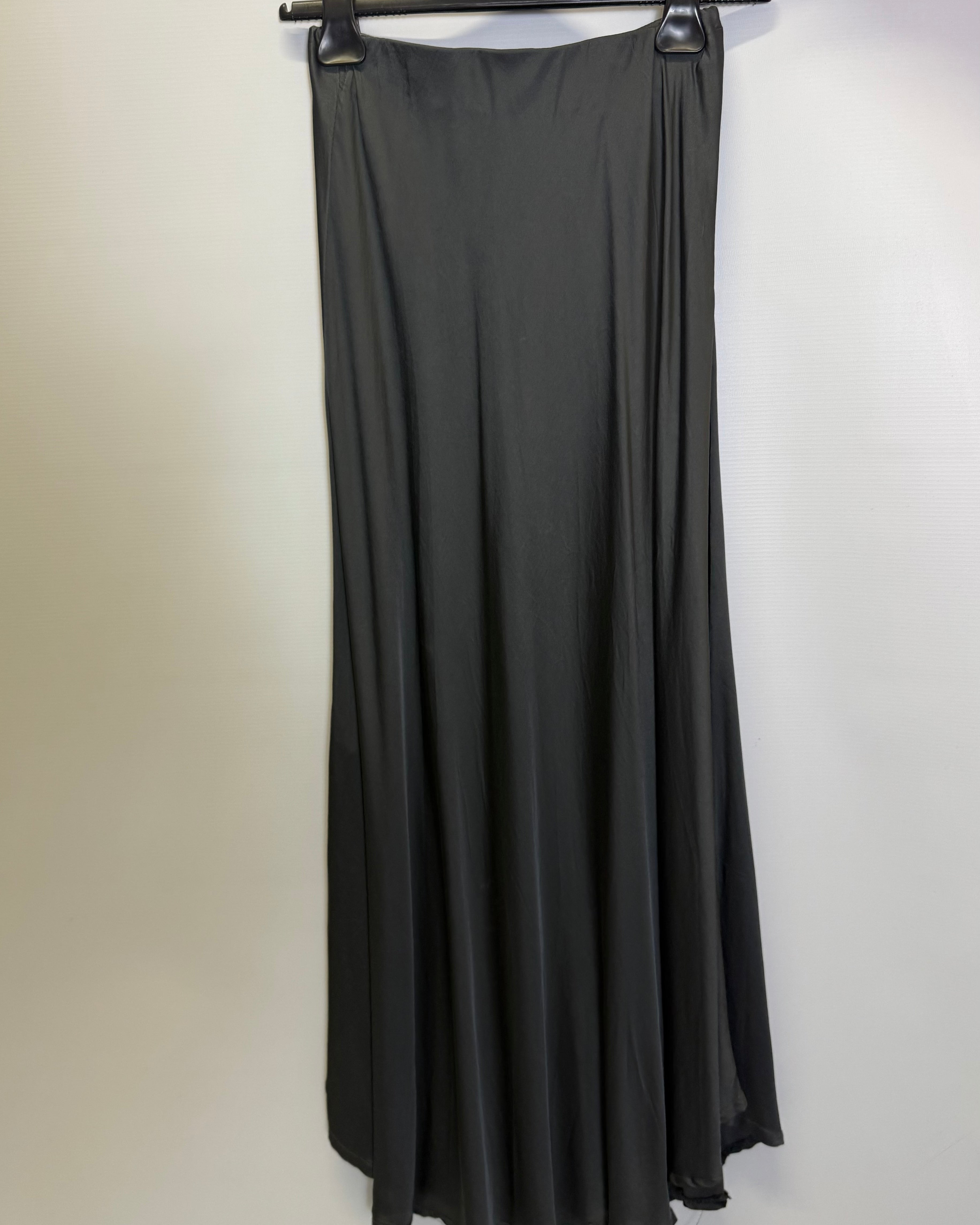 Black dress on a hanger against a white background