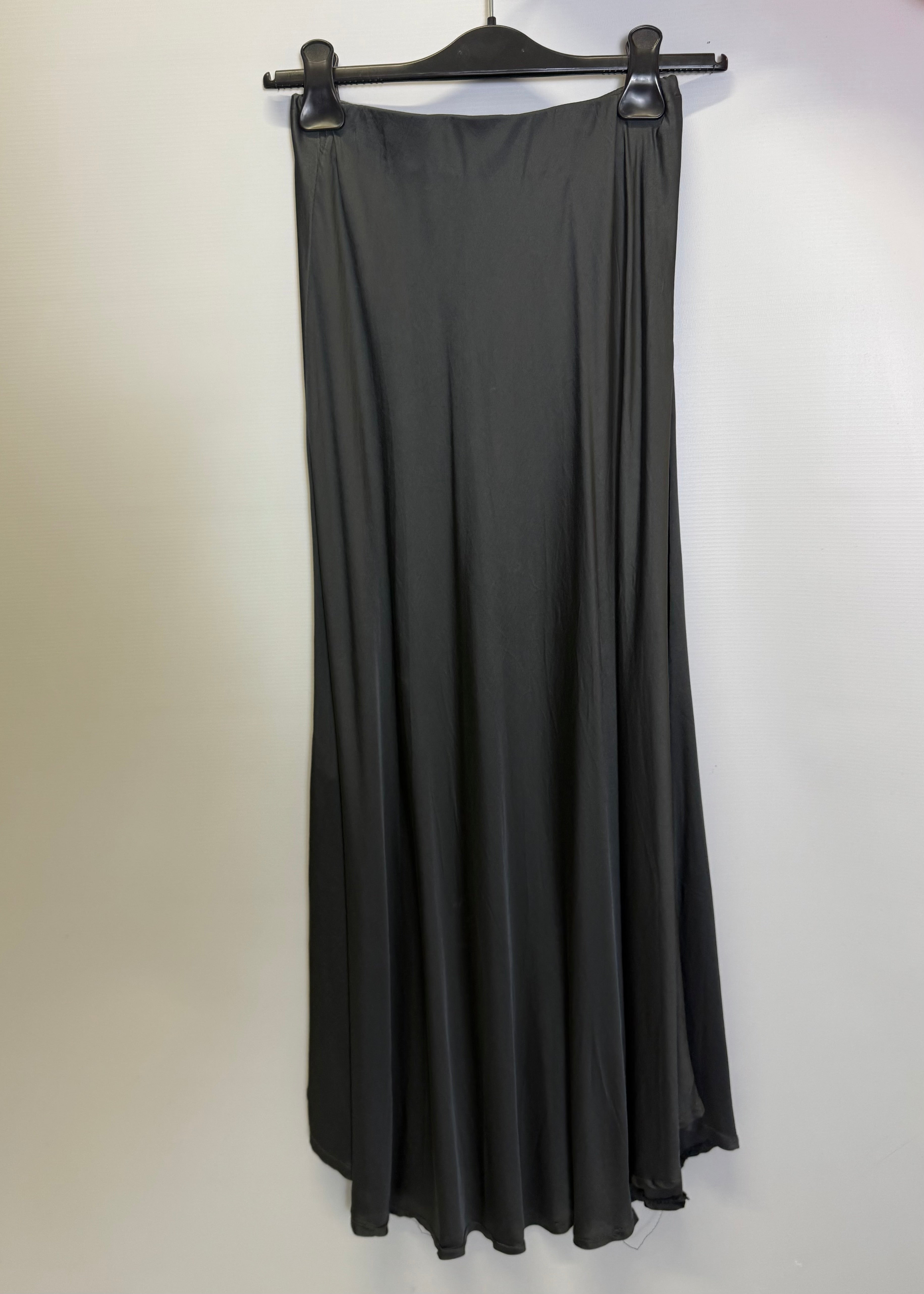 Black dress on a hanger against a white background