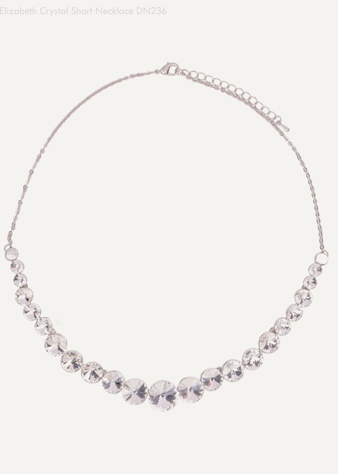 Silver necklace with clear crystals on a white background
