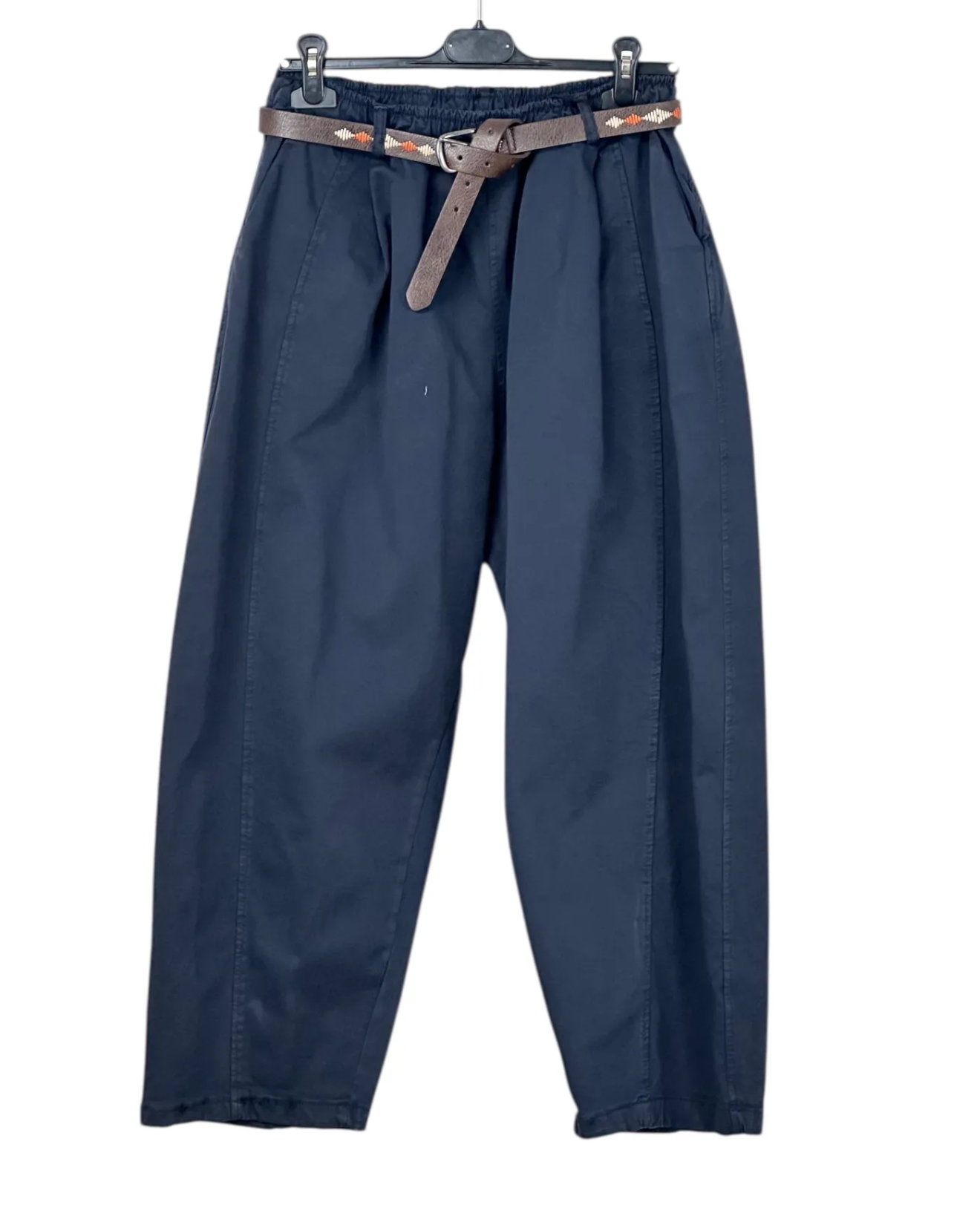 Blue pants with a belt on a hanger against a white background