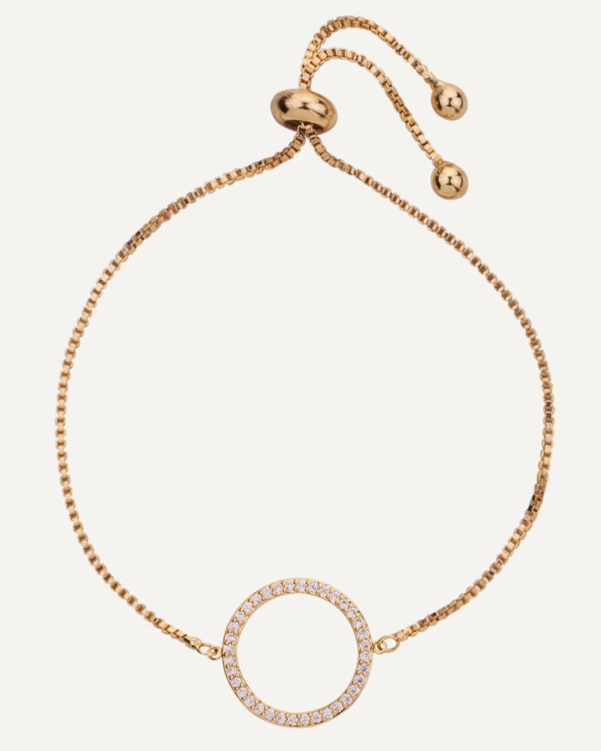 Gold bracelet with a circular design on a white background