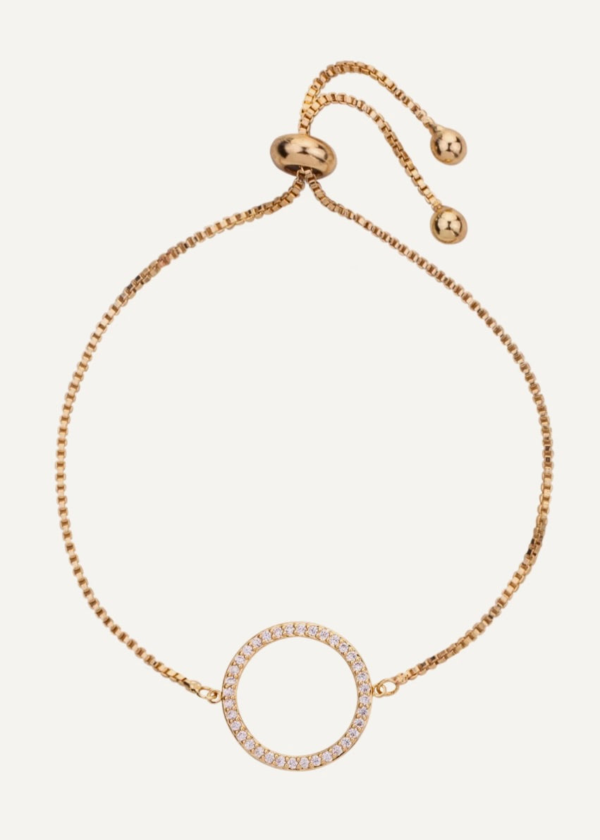 Gold bracelet with a circular design on a white background
