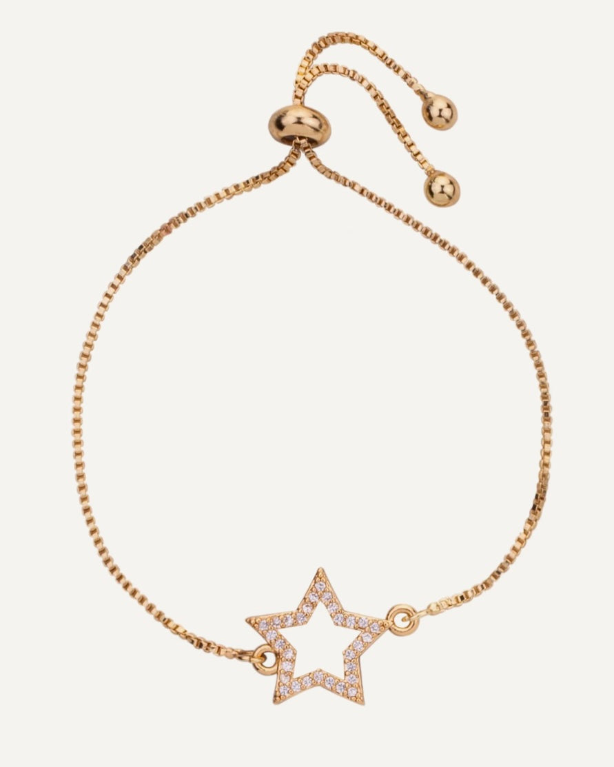 Gold bracelet with a star-shaped charm on a white background