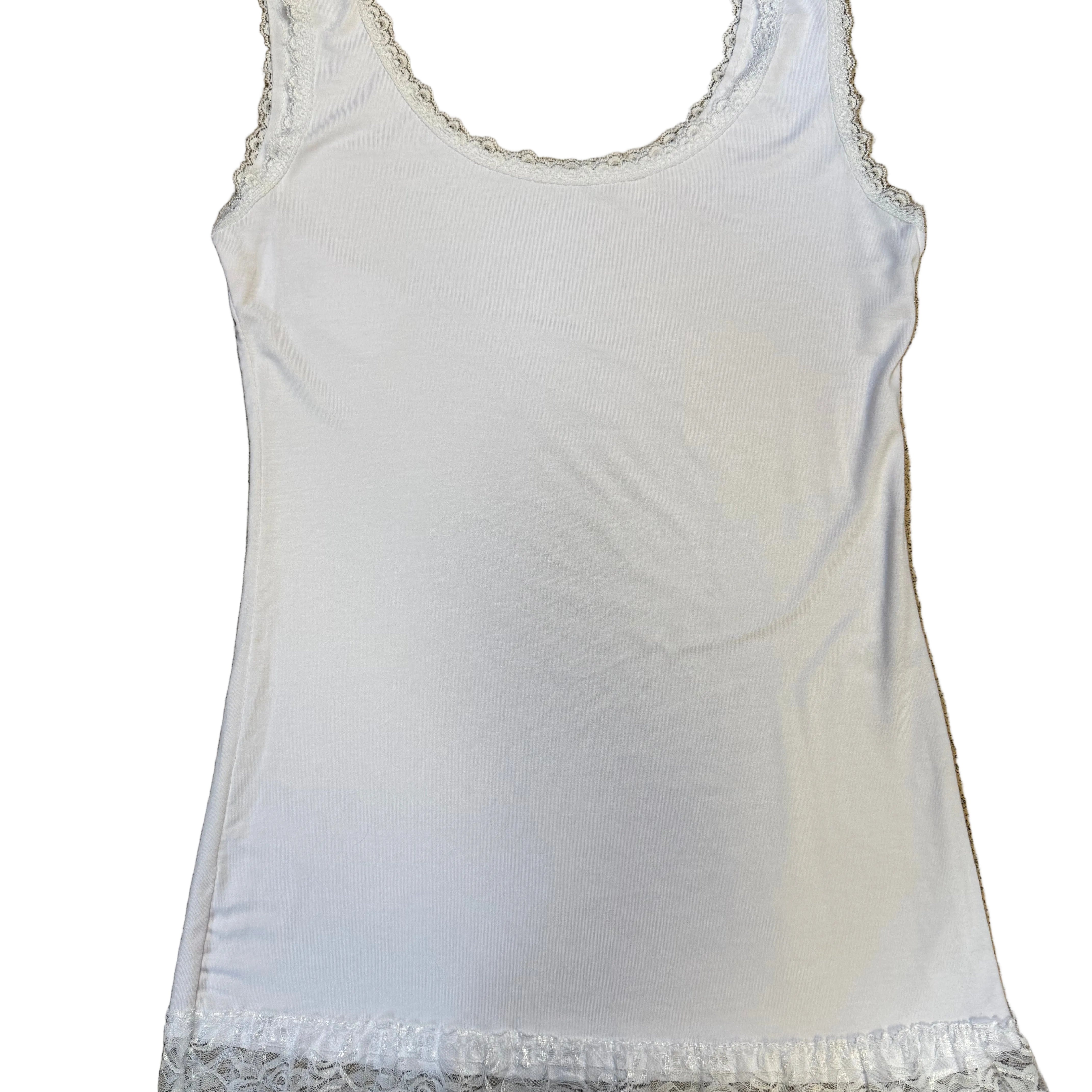 White tank top with lace trim on a brown surface