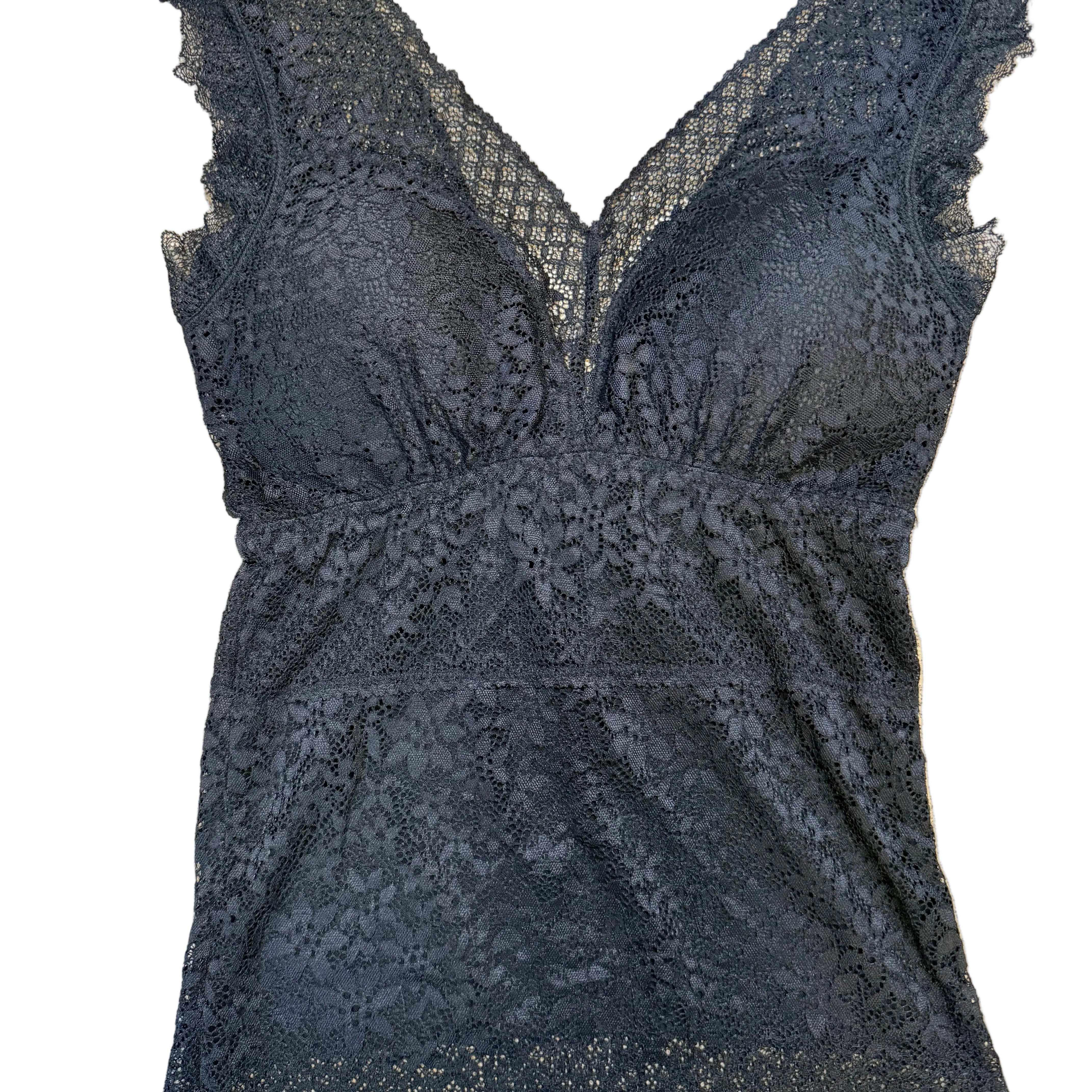 Black lace garment on a beige surface