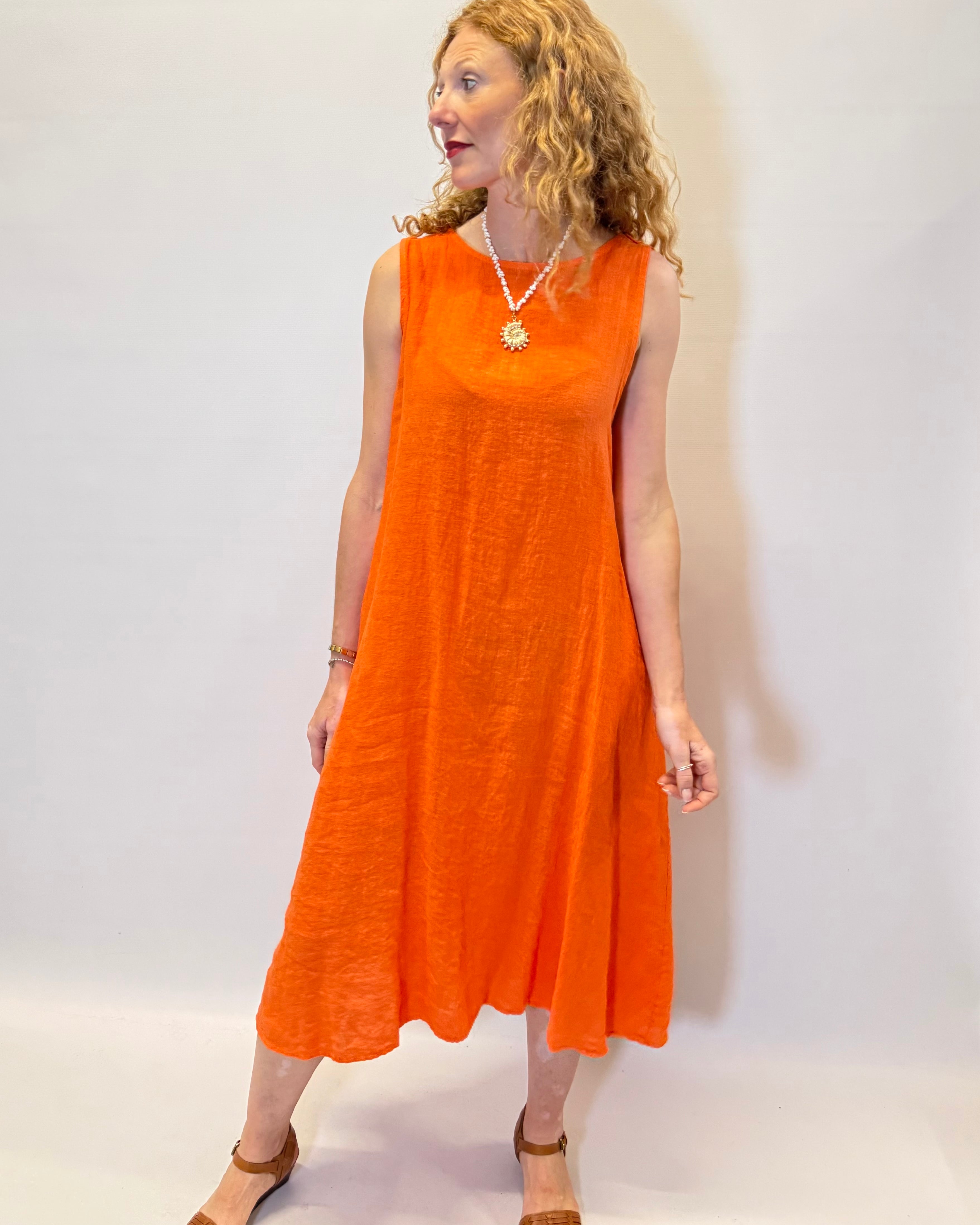 Woman wearing an orange dress against a white background