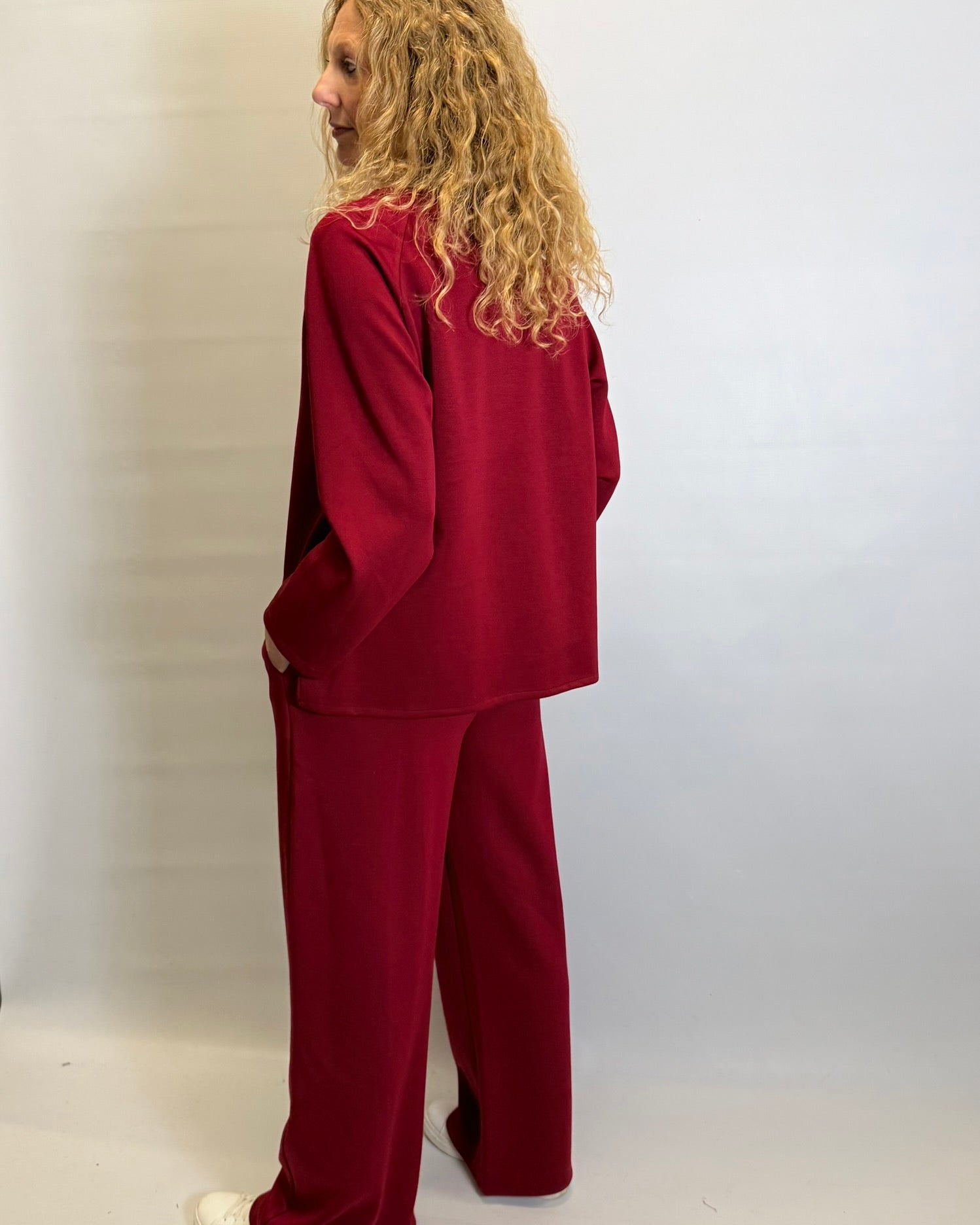 Person wearing a red outfit against a plain background