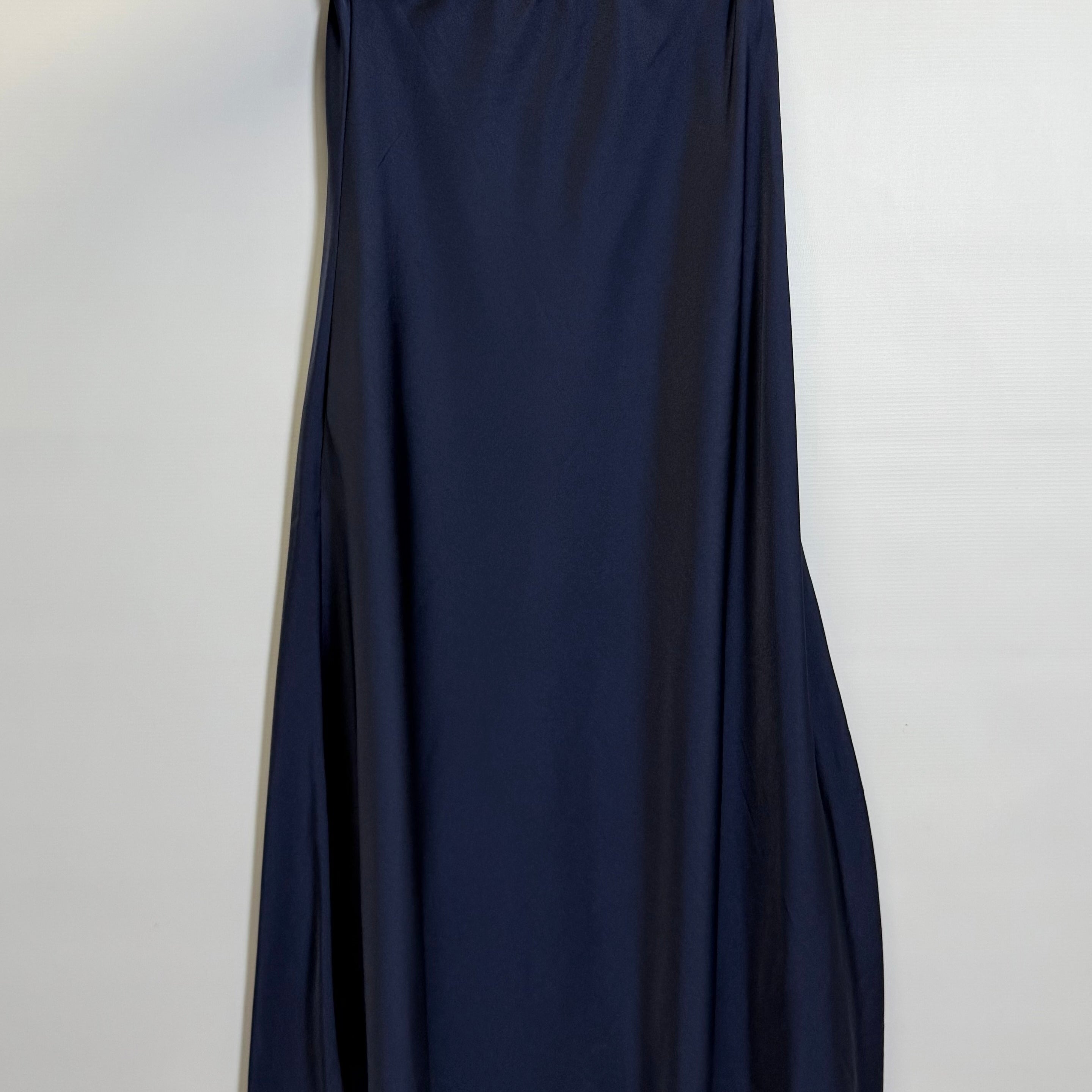 Navy blue skirt hanging on a hanger against a white background