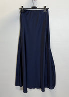 Navy blue skirt hanging on a hanger against a white background