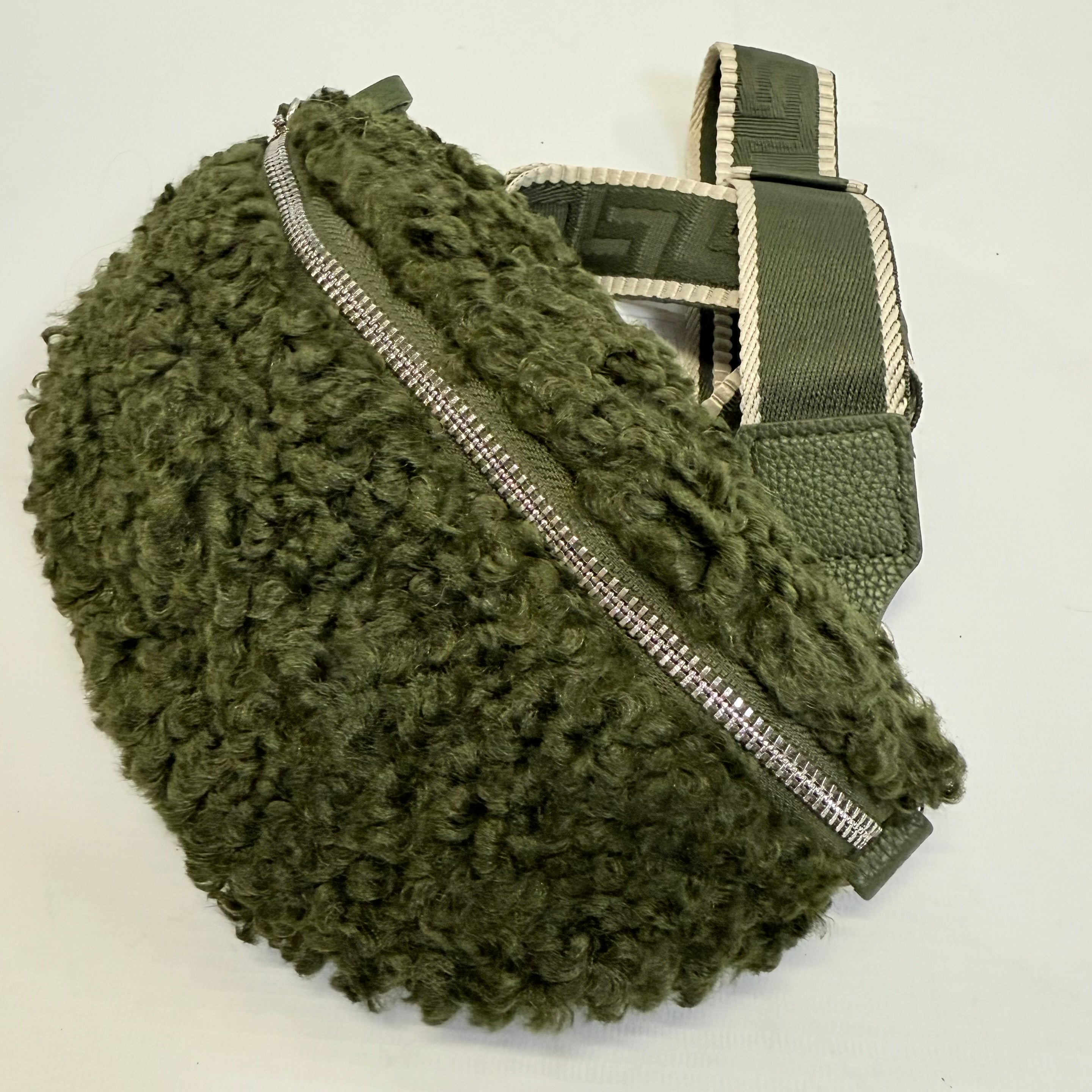 Green textured bag with a zipper on a white background