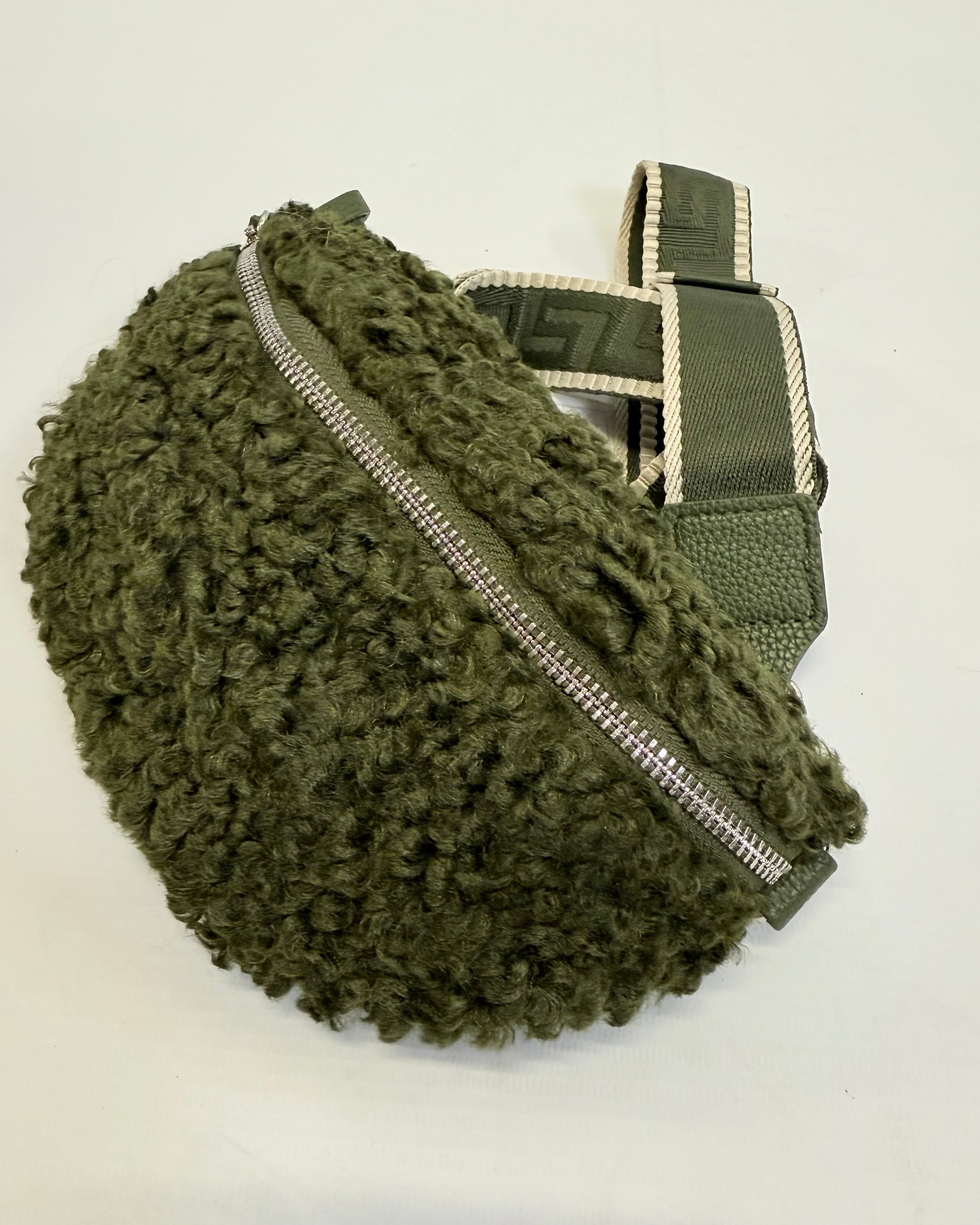 Green textured bag with a zipper on a white background