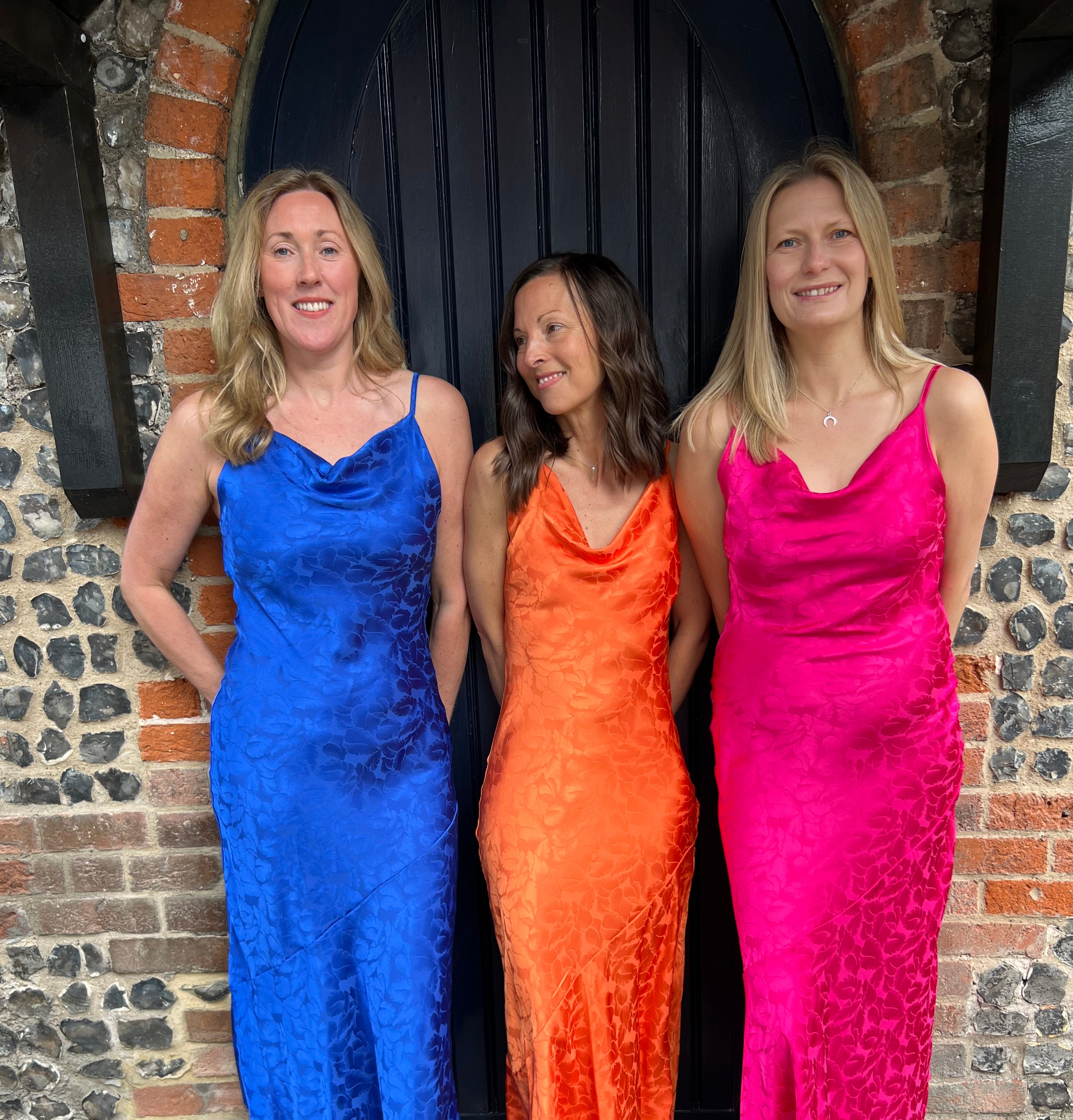 Vibrant summer dresses in royal blue, fuschia pink and orange. With dainty straps and a subtle flower pattern.