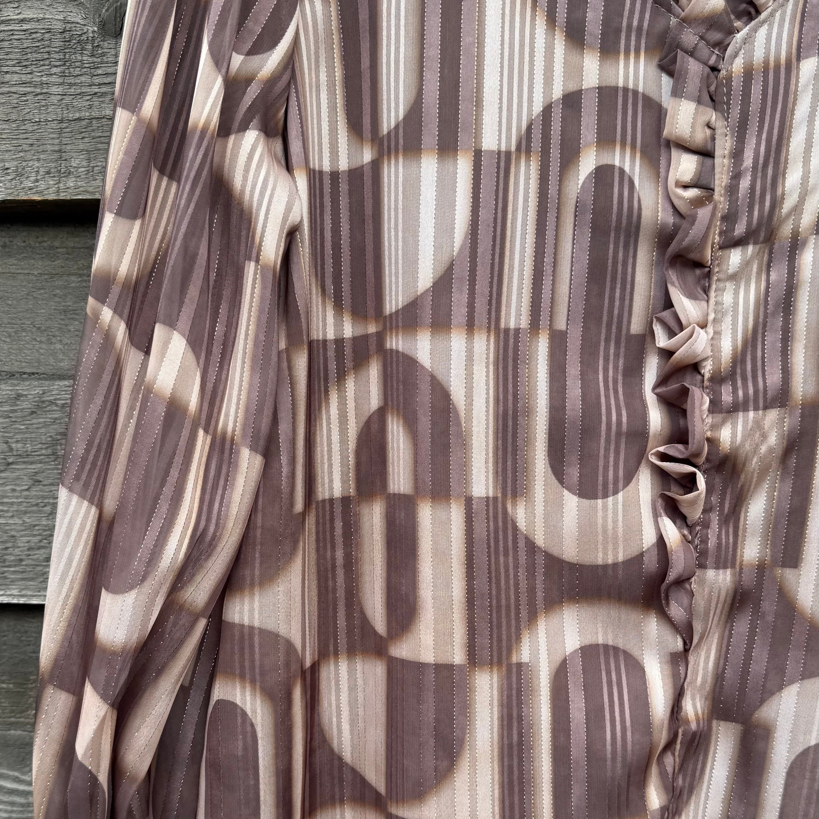 Brown and beige patterned fabric draped over a wooden surface