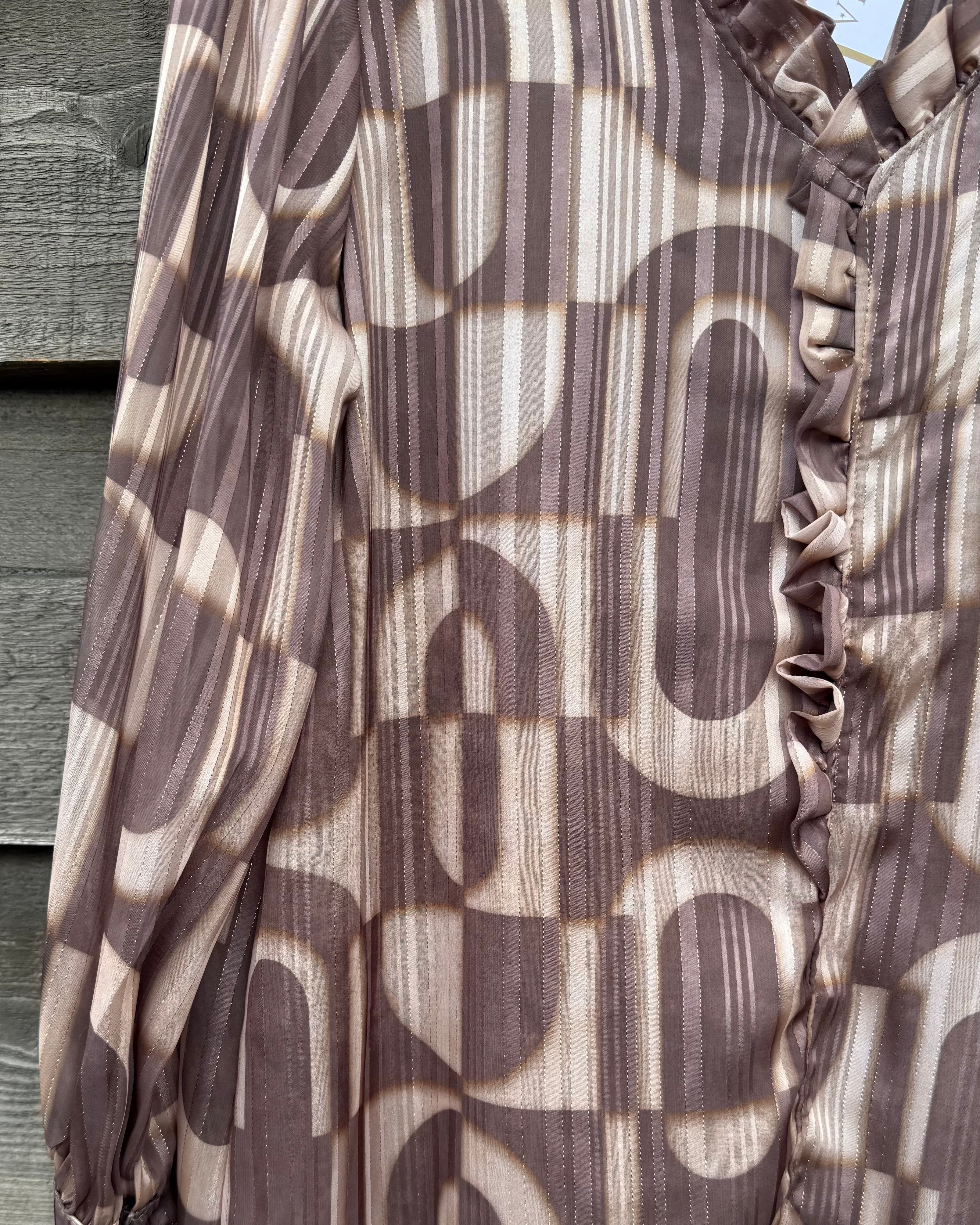 Brown and beige patterned fabric draped over a wooden surface