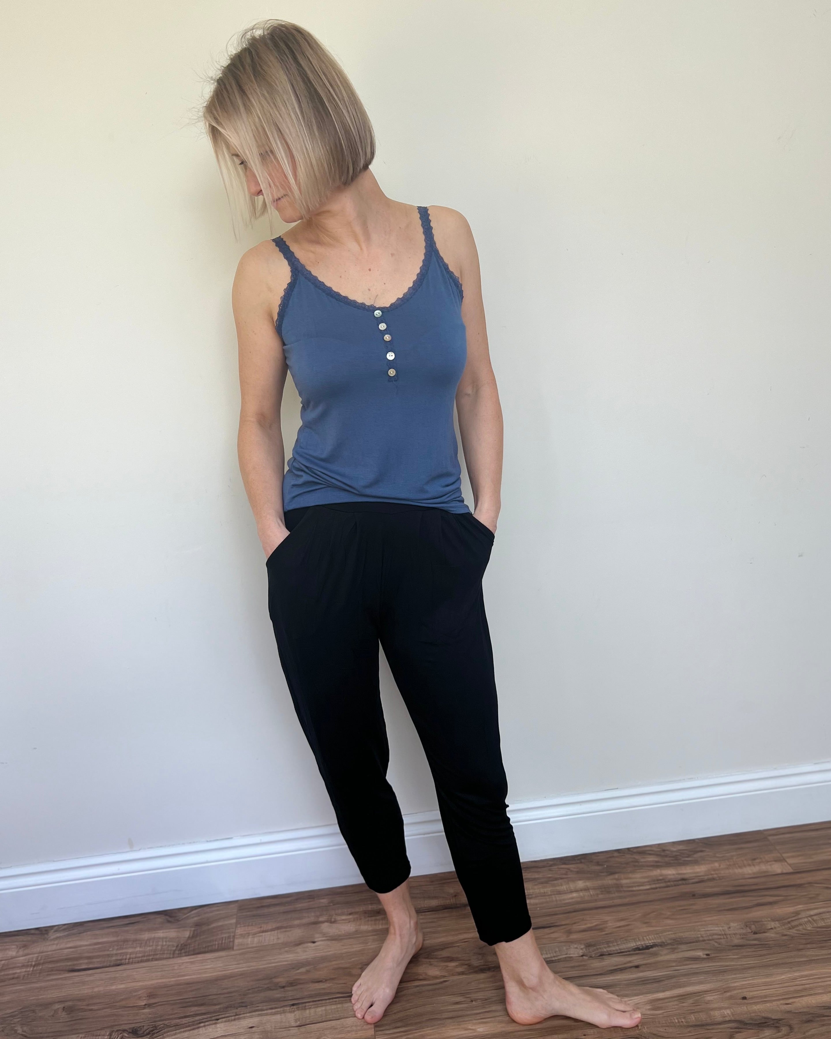 Person standing against a white background wearing a blue strati vest