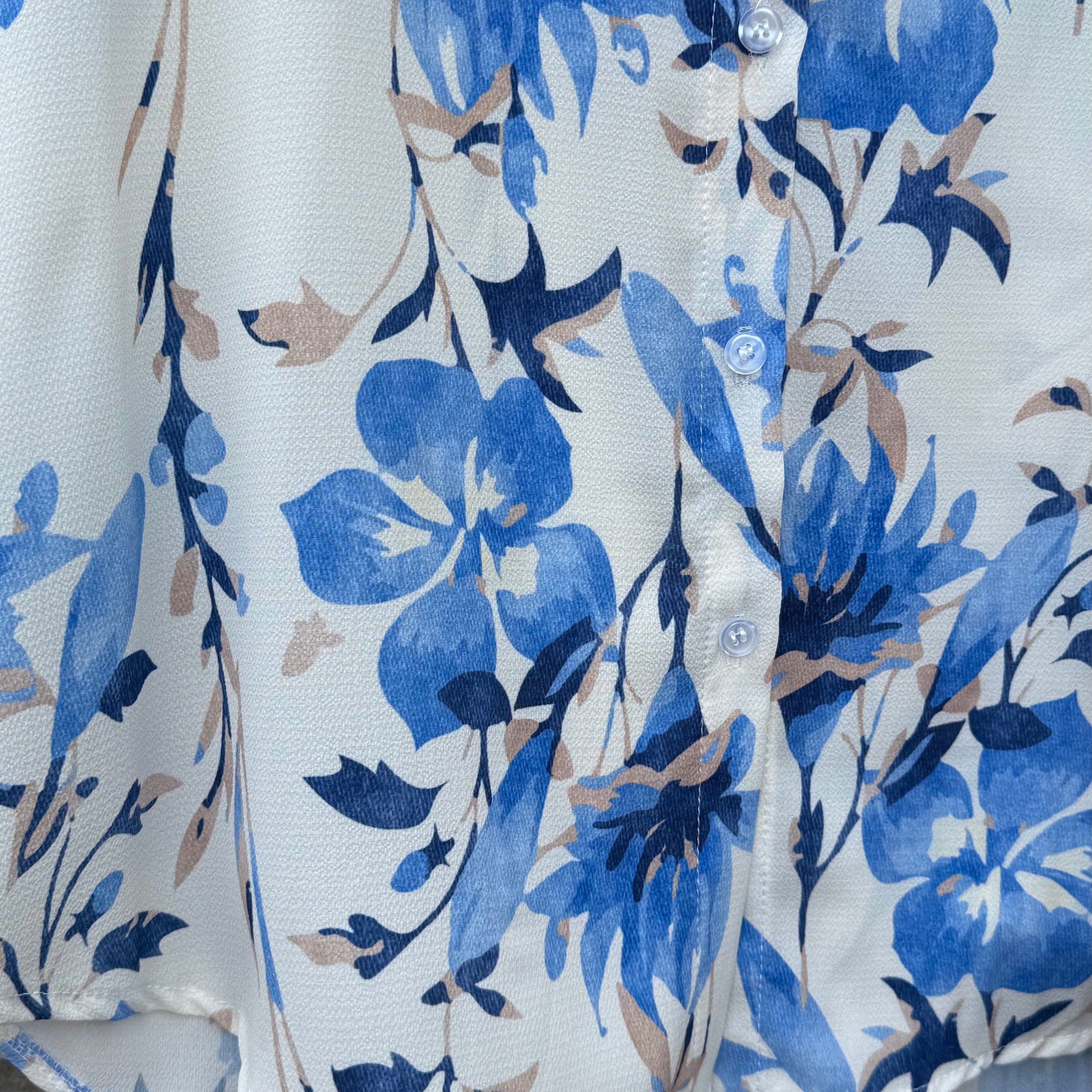 White shirt with blue floral pattern on a wooden surface