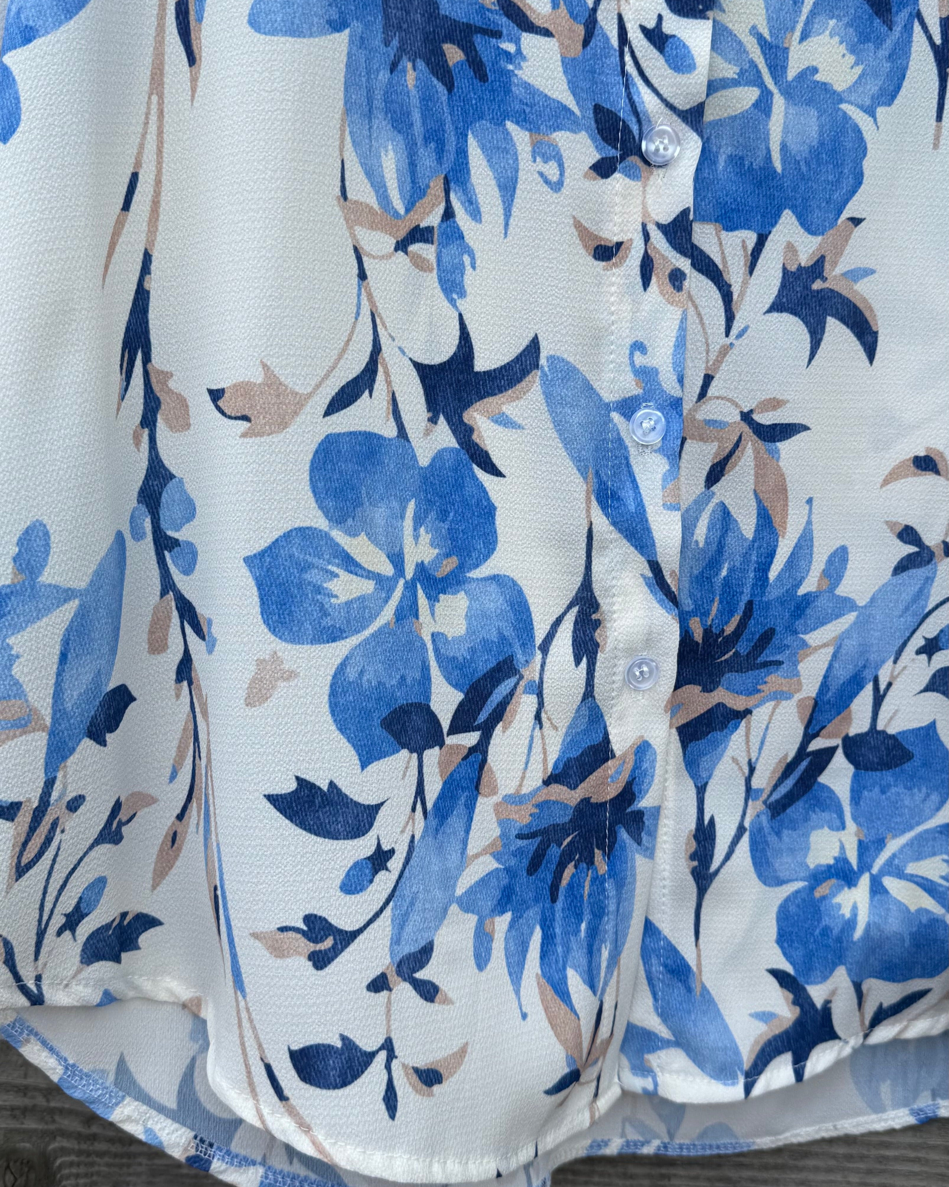 White shirt with blue floral pattern on a wooden surface