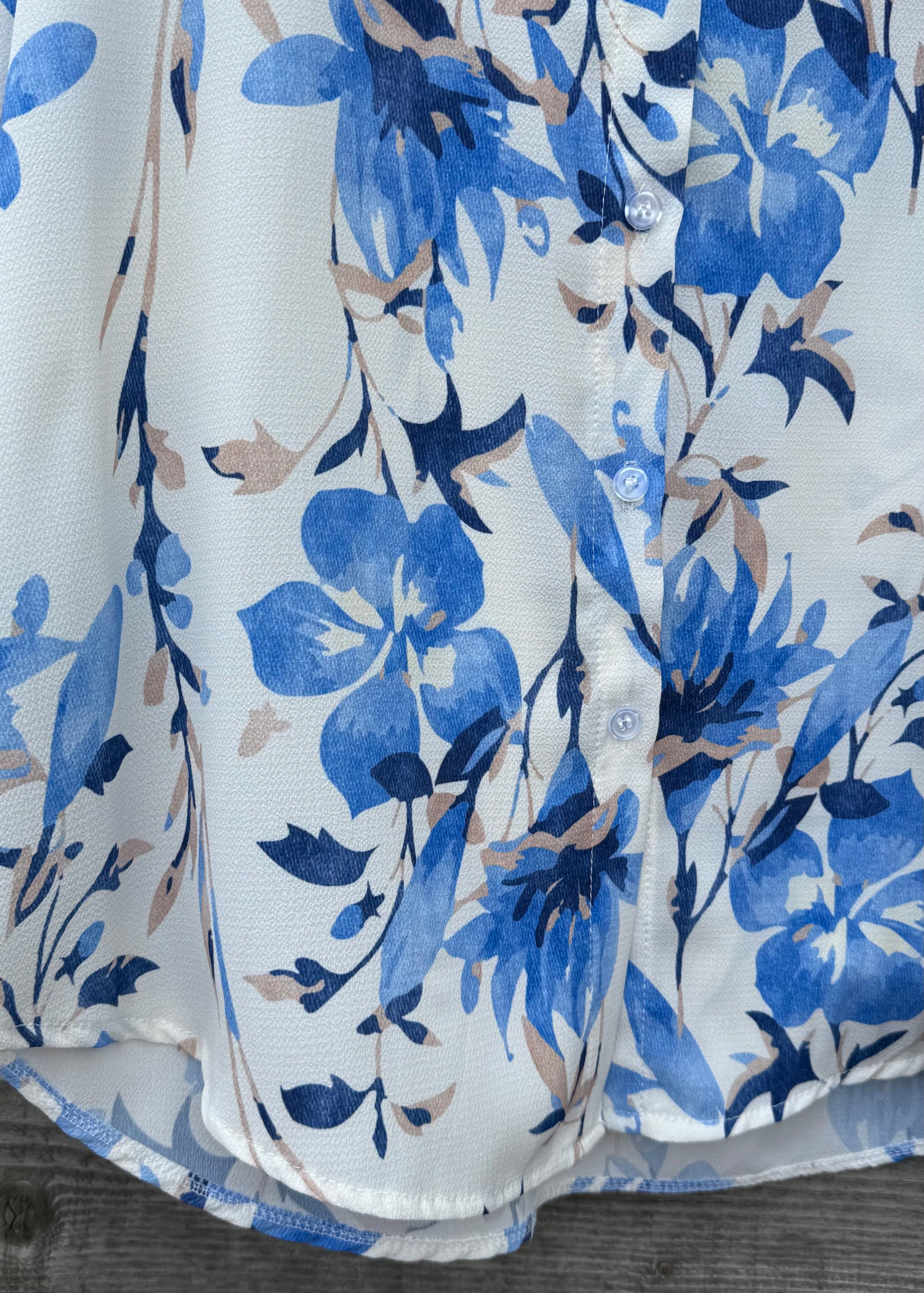 White shirt with blue floral pattern on a wooden surface