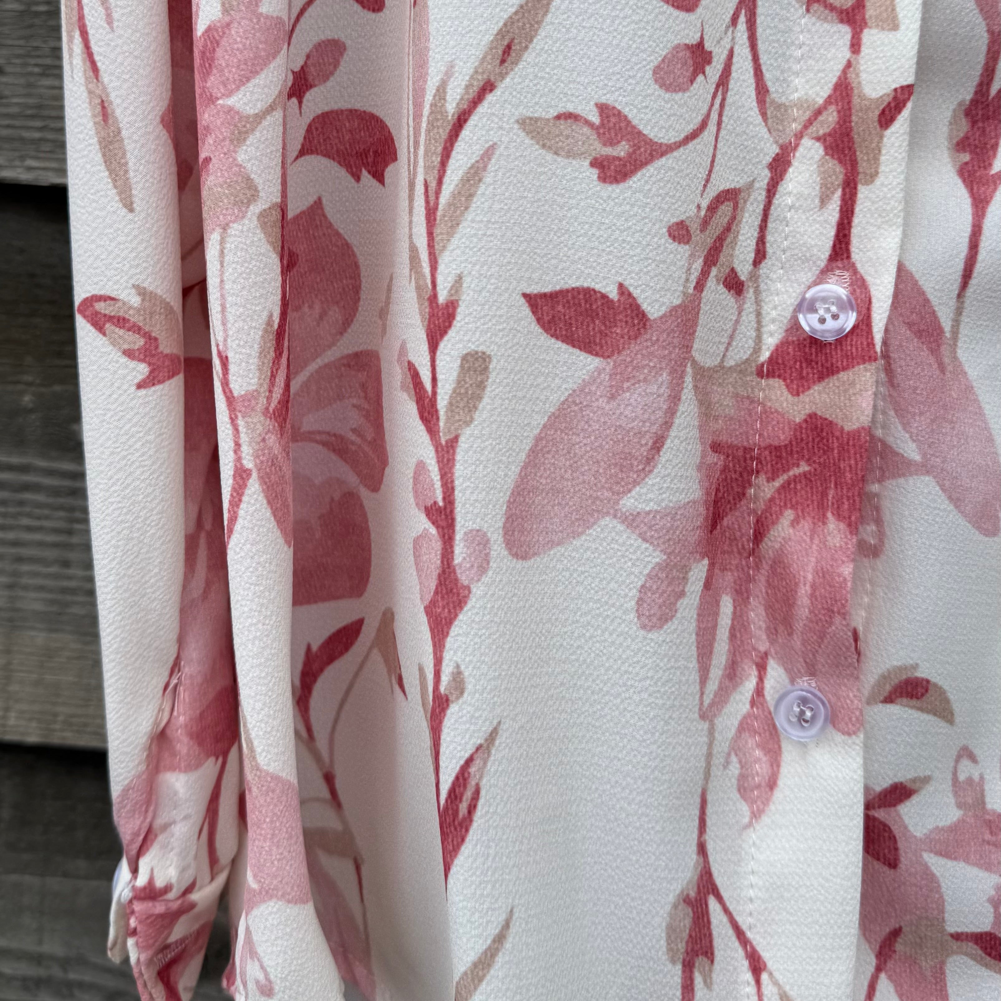 Floral patterned fabric with red and pink flowers on a white background