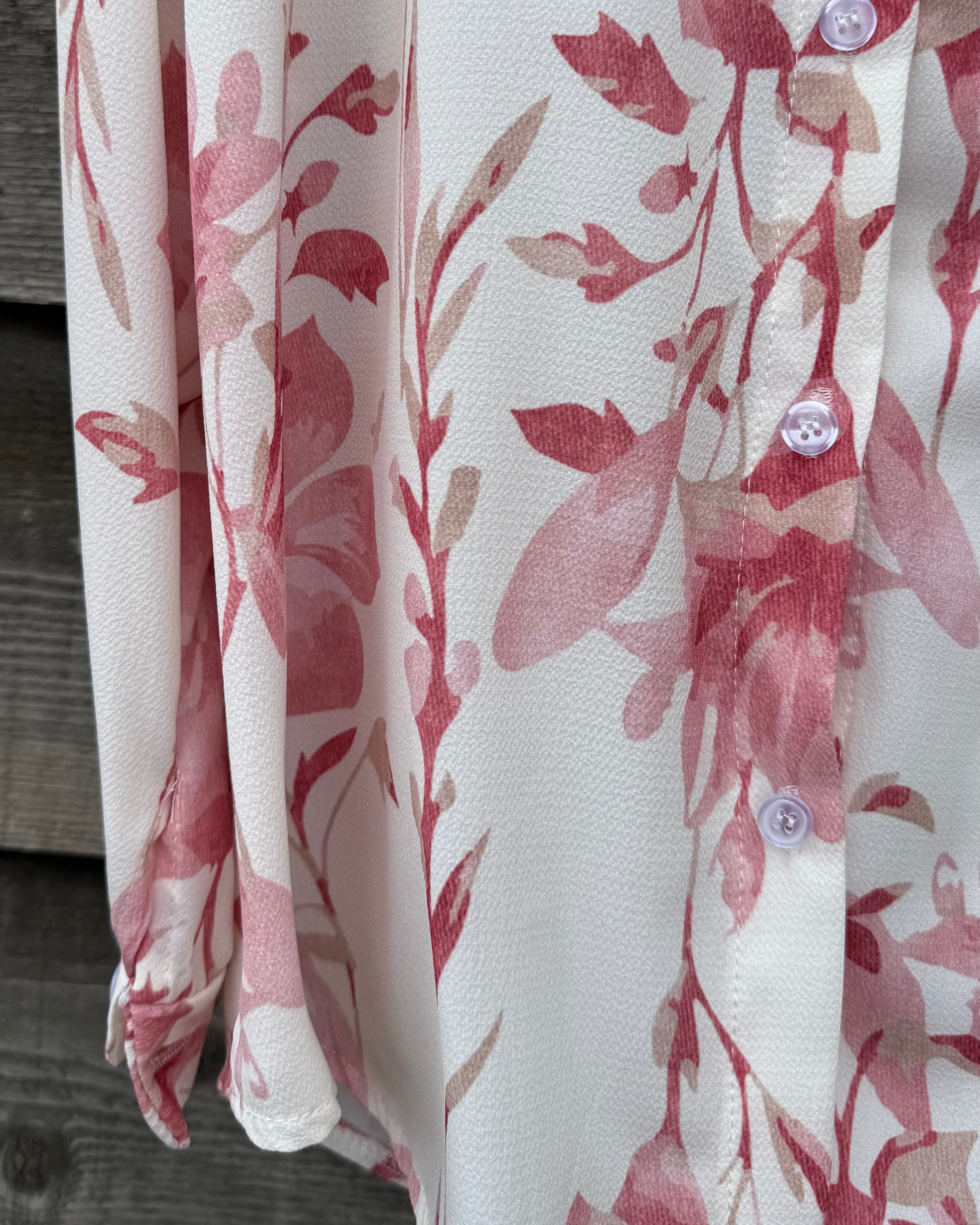 Floral patterned fabric with red and pink flowers on a white background