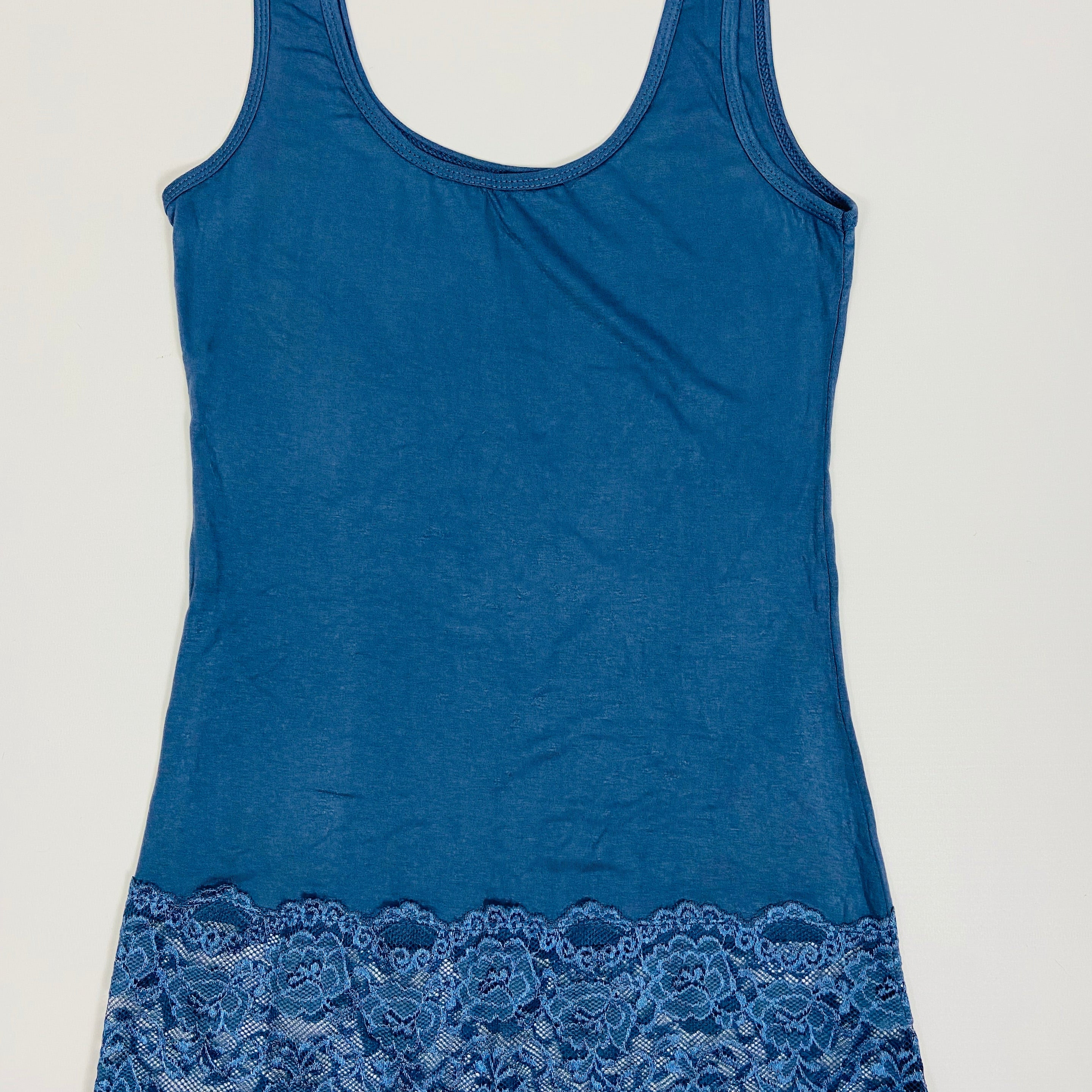 Blue tank top with lace trim on a light gray background