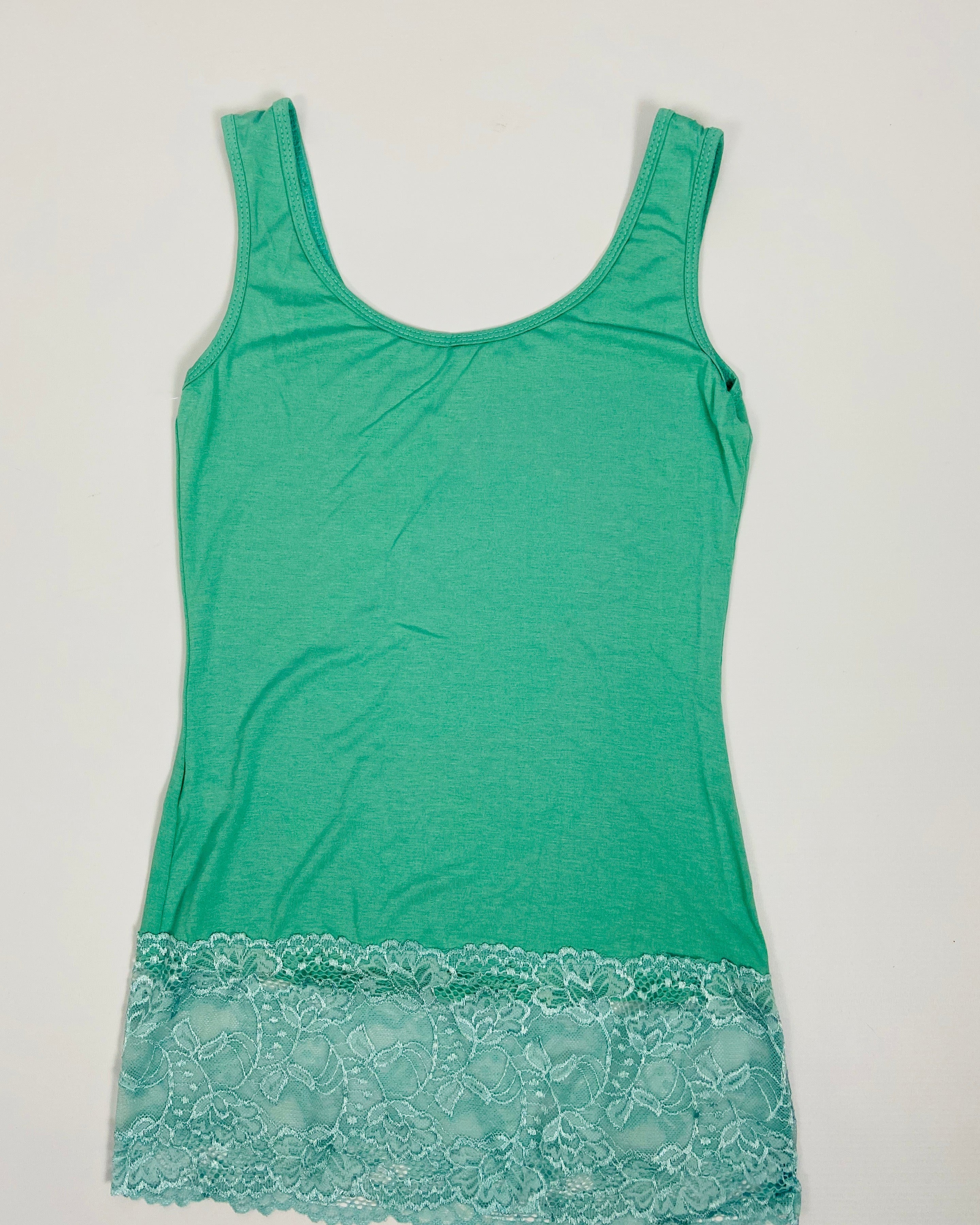 Green tank top with lace trim on a light gray background