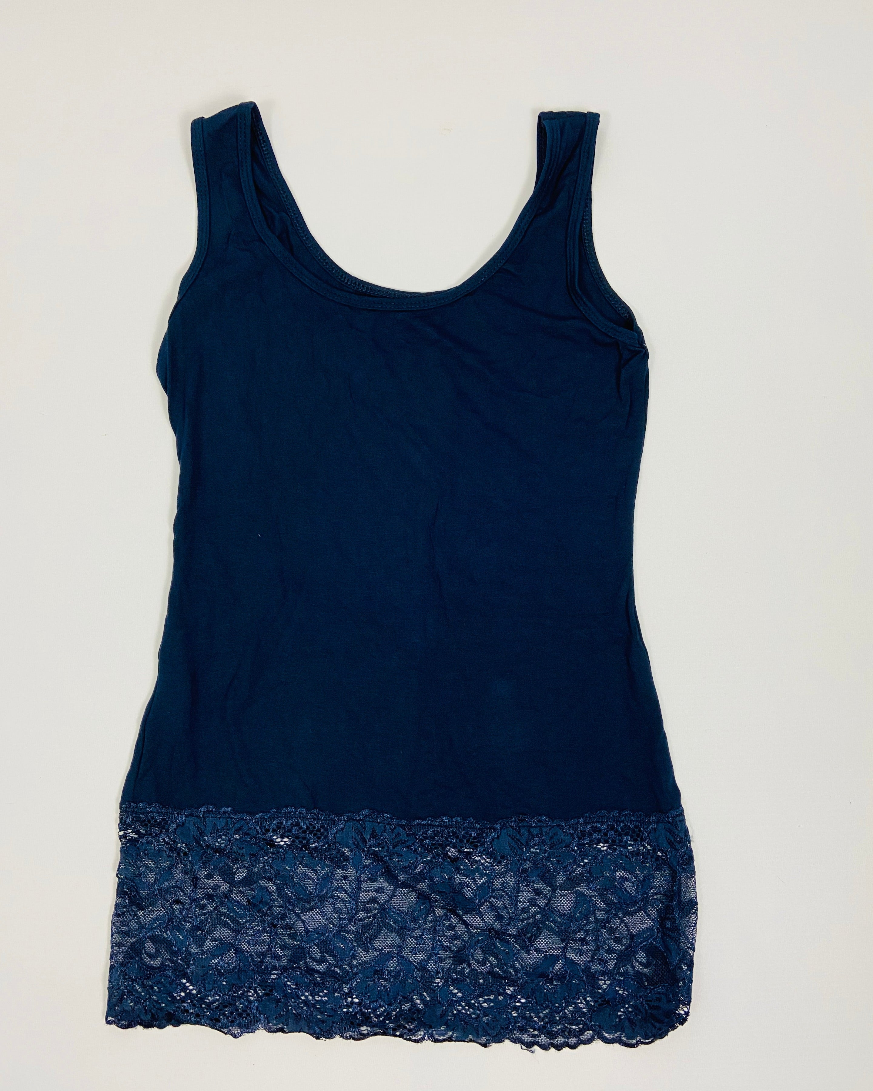 Navy blue tank top with lace trim on a white background