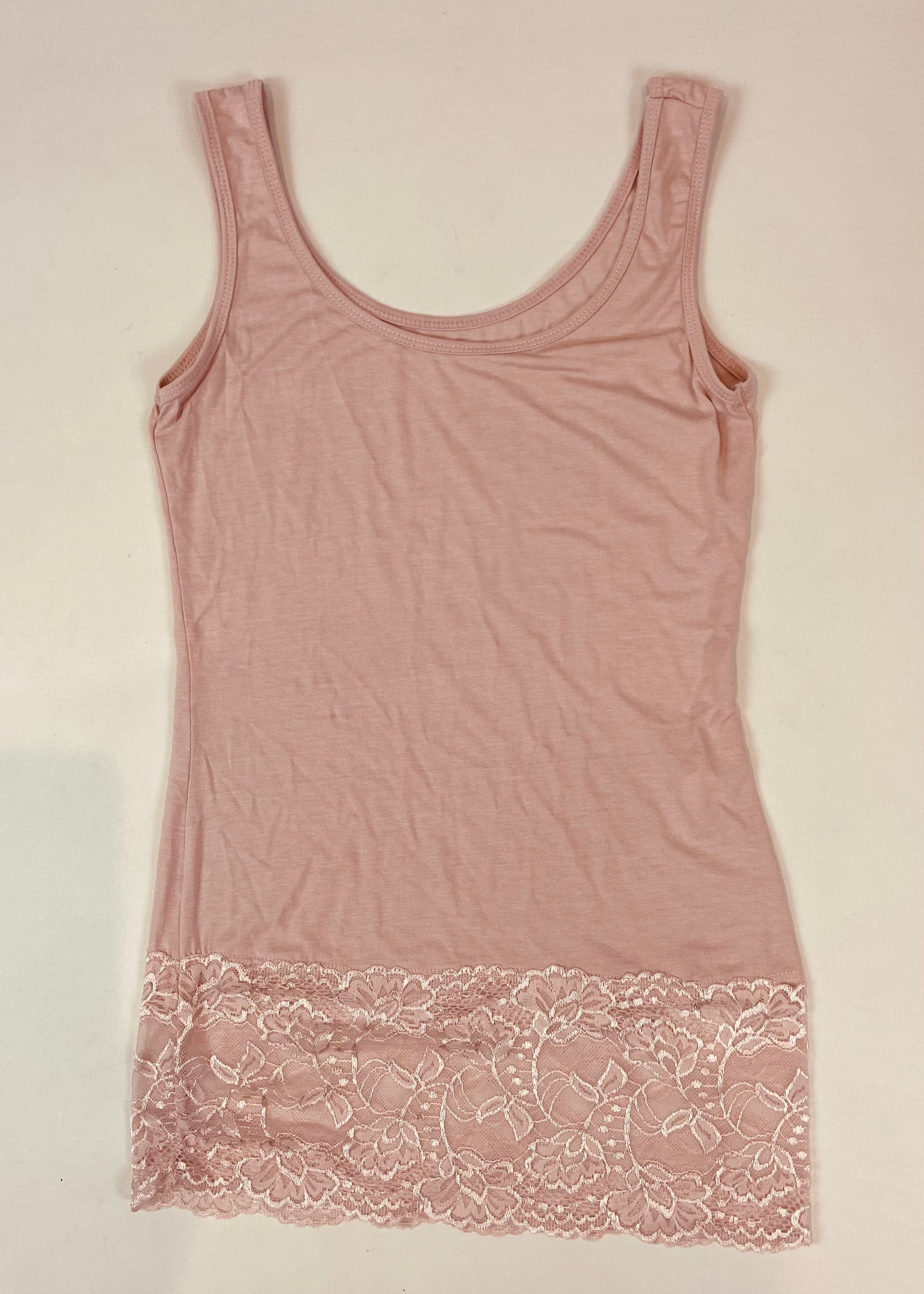 Pink tank top with lace trim on a light background