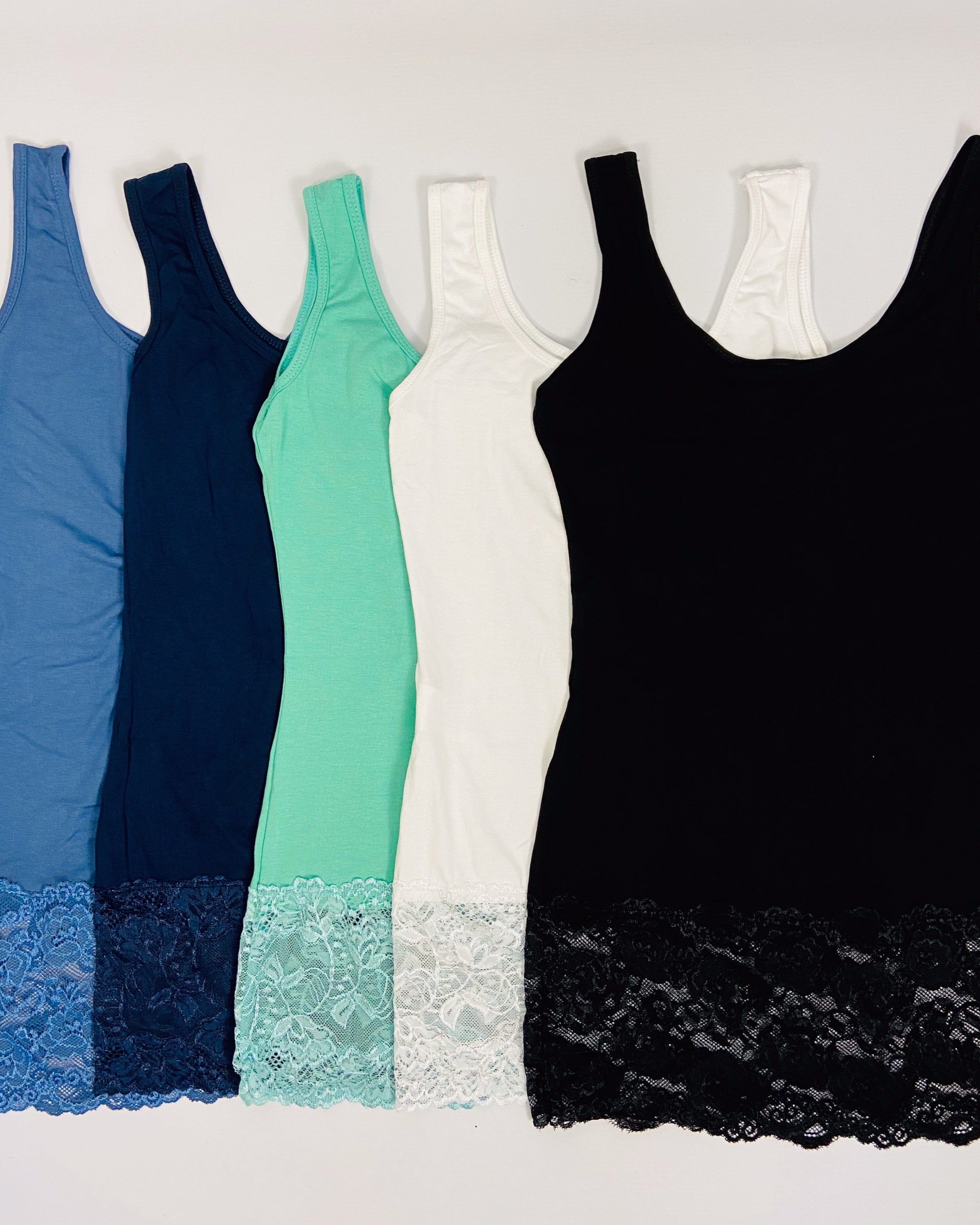 Five tank tops in blue, navy, green, white, and black with lace trim on a white background.