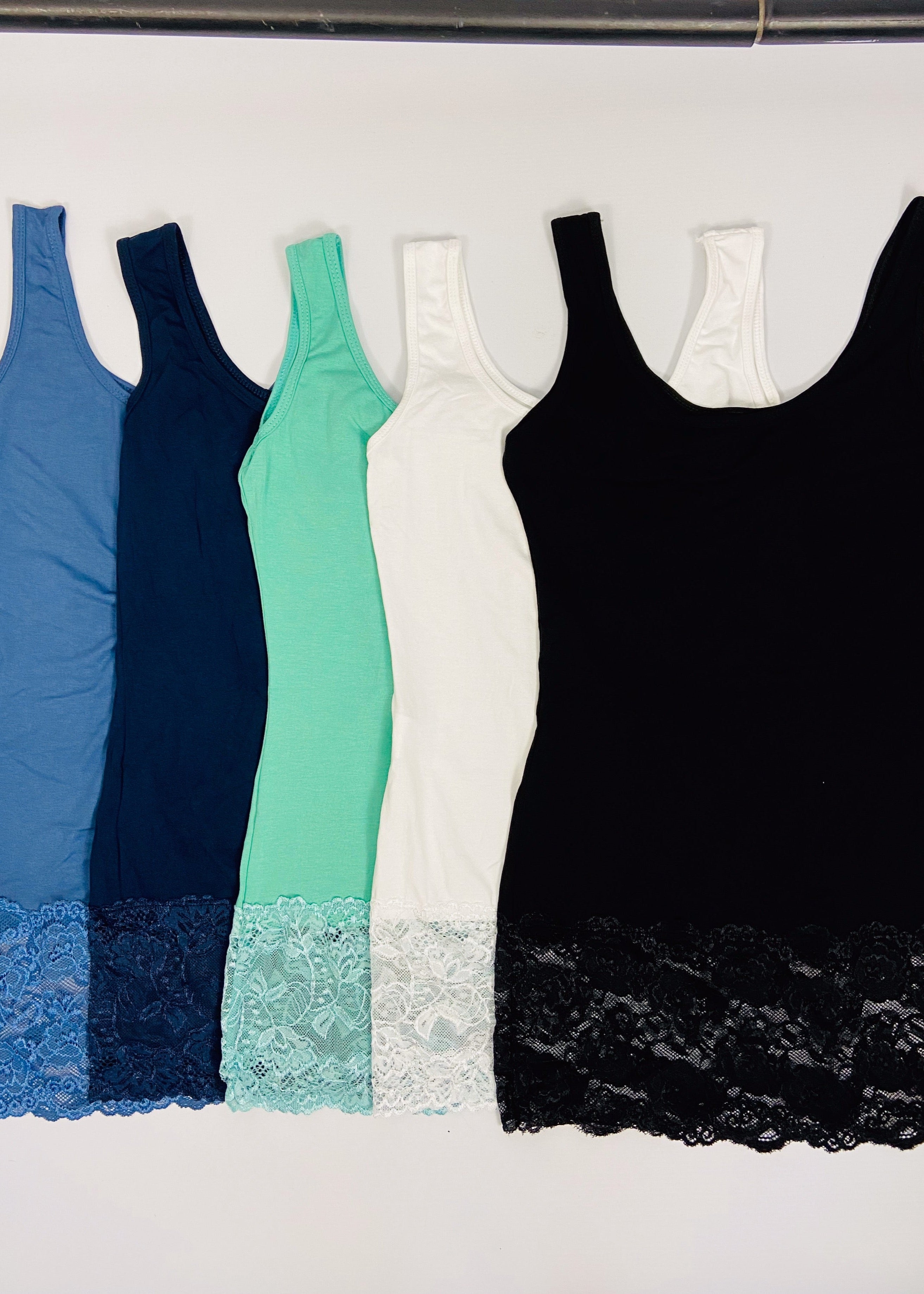 Five tank tops in blue, navy, green, white, and black with lace trim on a white background.
