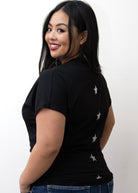 A person wearing a black V-neck t-shirt with the back design showing five silver stars.
