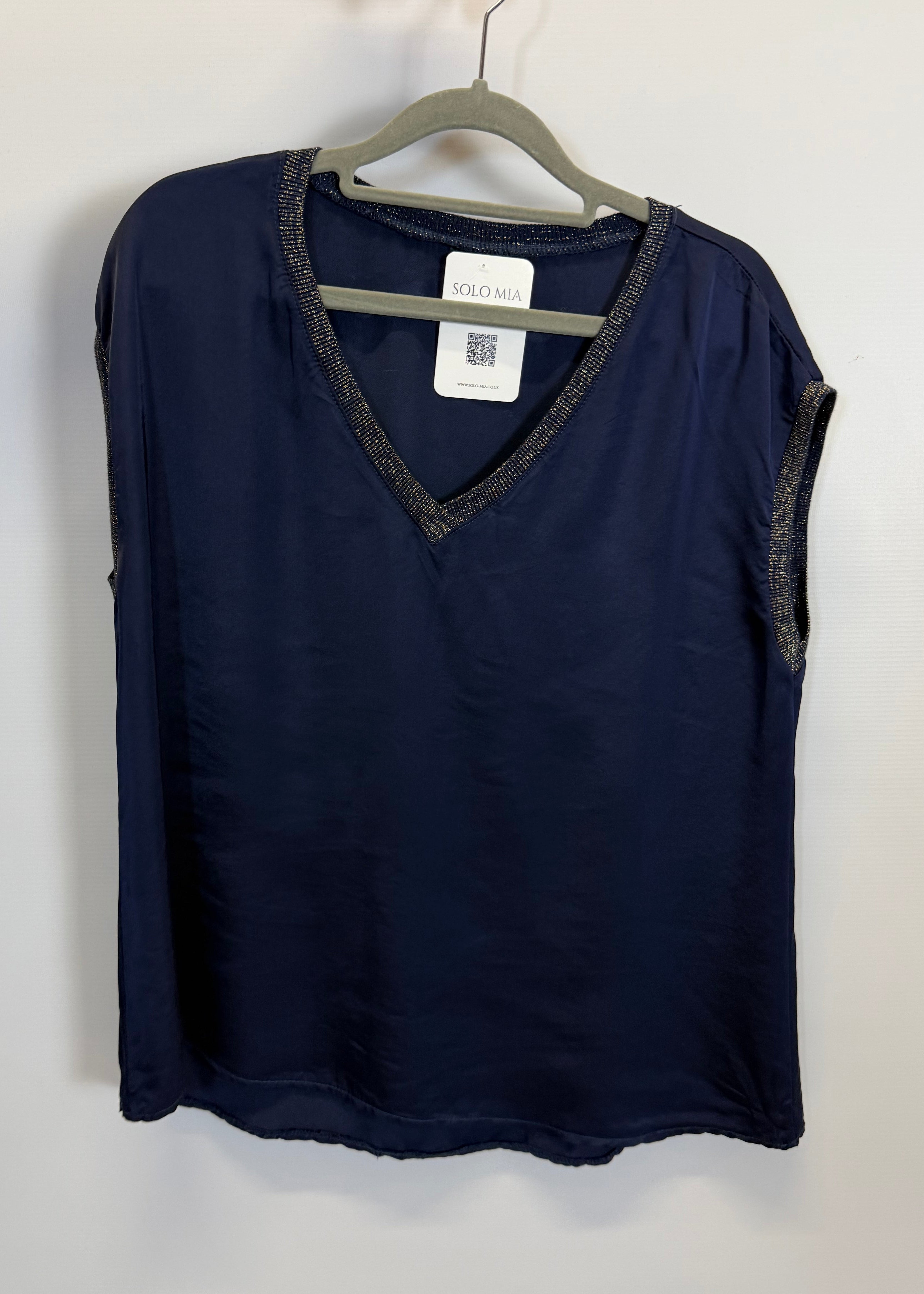 Folded navy blue garment with a tag on a white background