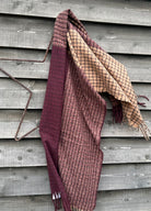 Plaid blanket draped over a wooden surface