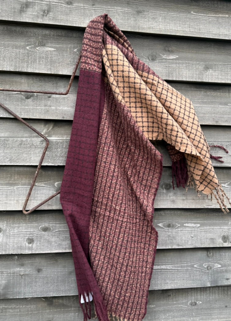 Plaid blanket draped over a wooden surface