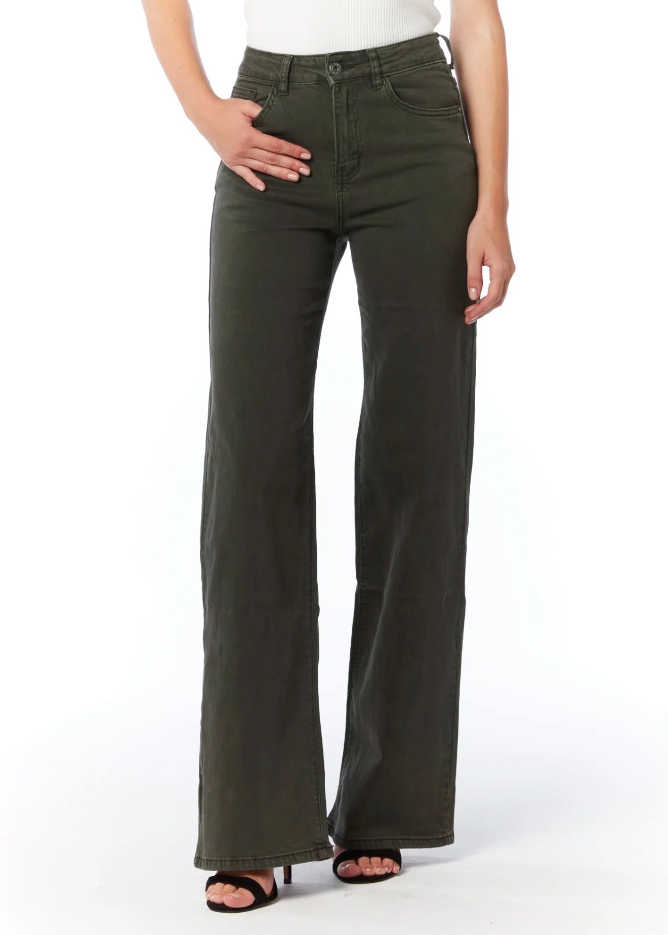 A model wearing a pair of dark olive green wide-leg jeans with a white top and black sandals, shown from the waist down against a white studio background.