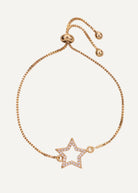 Gold bracelet with a star-shaped charm on a white background