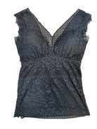 Black lace garment on a beige surface