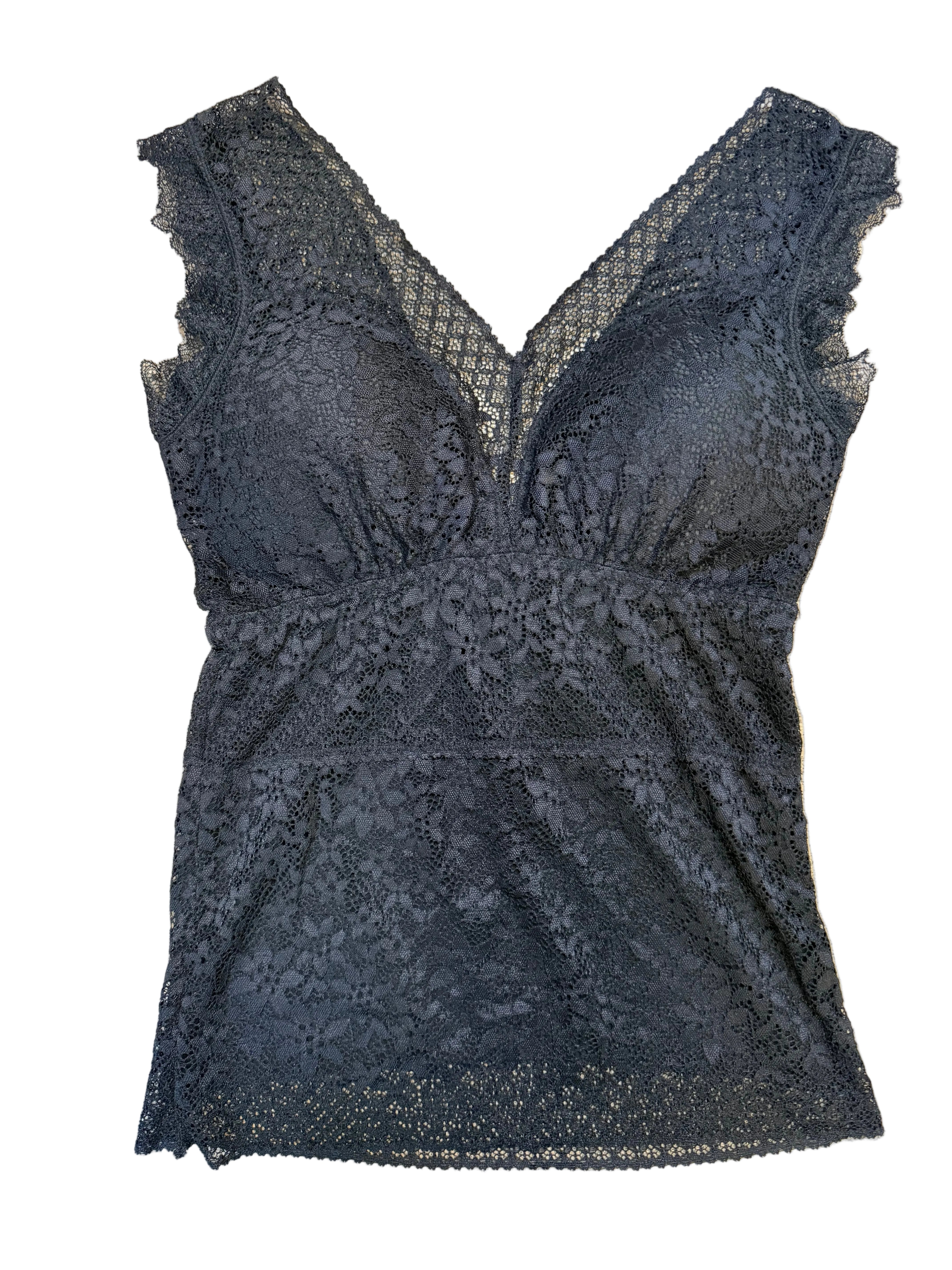 Black lace garment on a beige surface