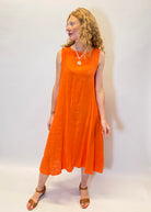 Woman wearing an orange dress against a white background