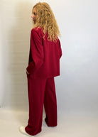 Person wearing a red outfit against a plain background