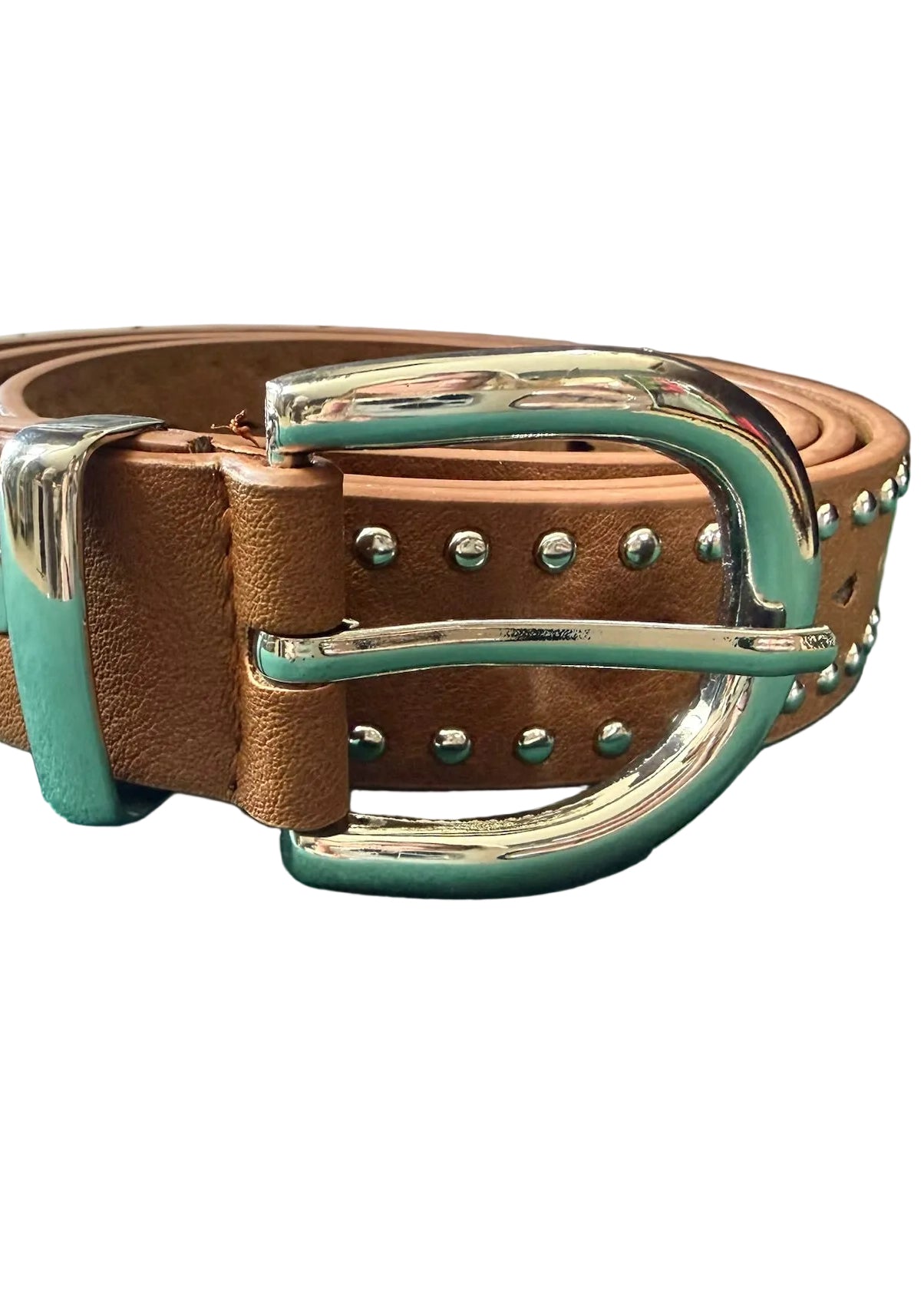 Brown leather belt with silver buckle on a green surface