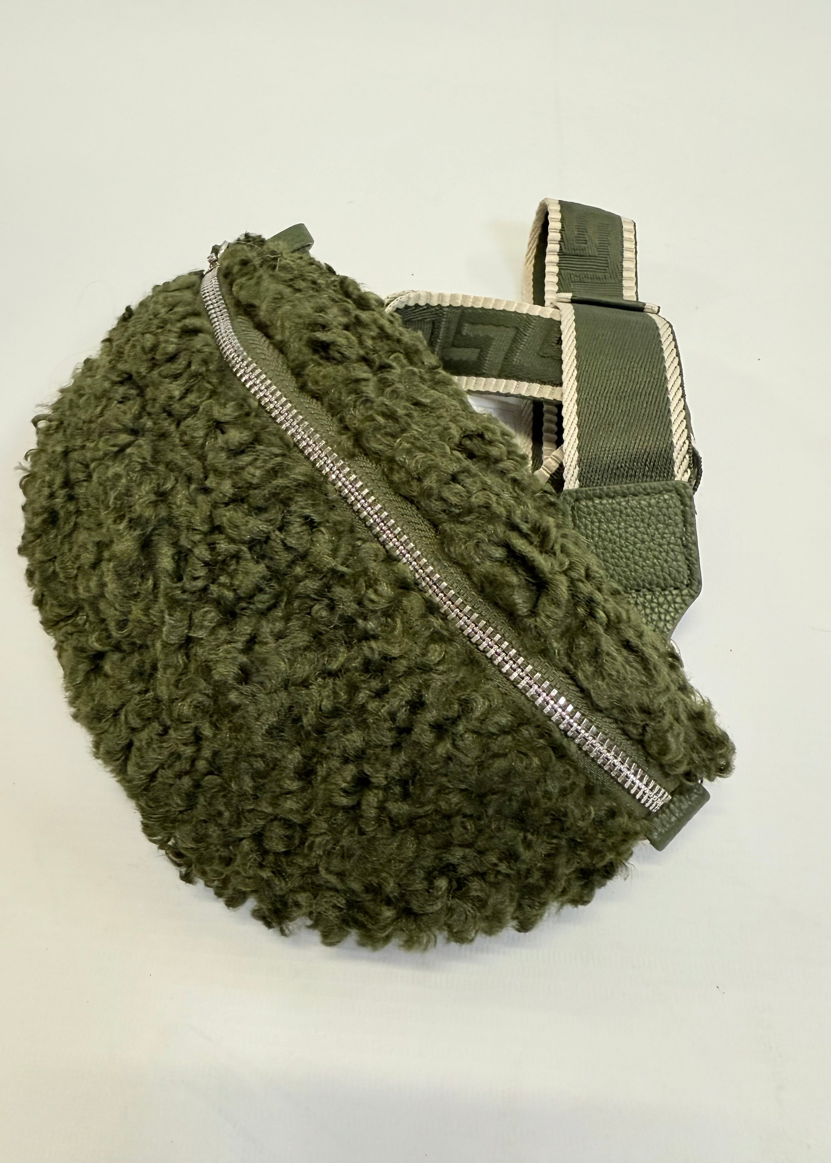 Green textured bag with a zipper on a white background