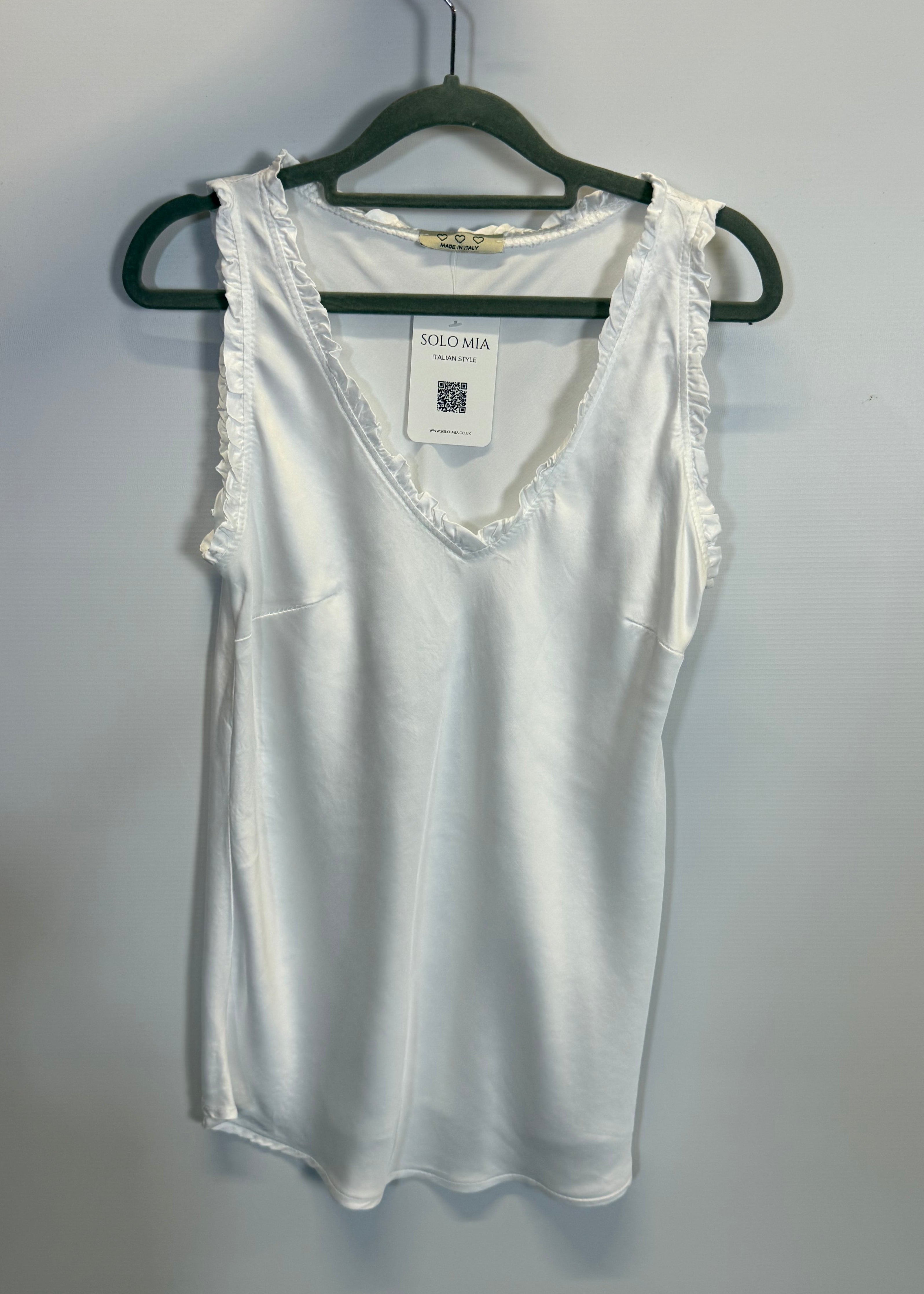 White blouse on a hanger against a white background