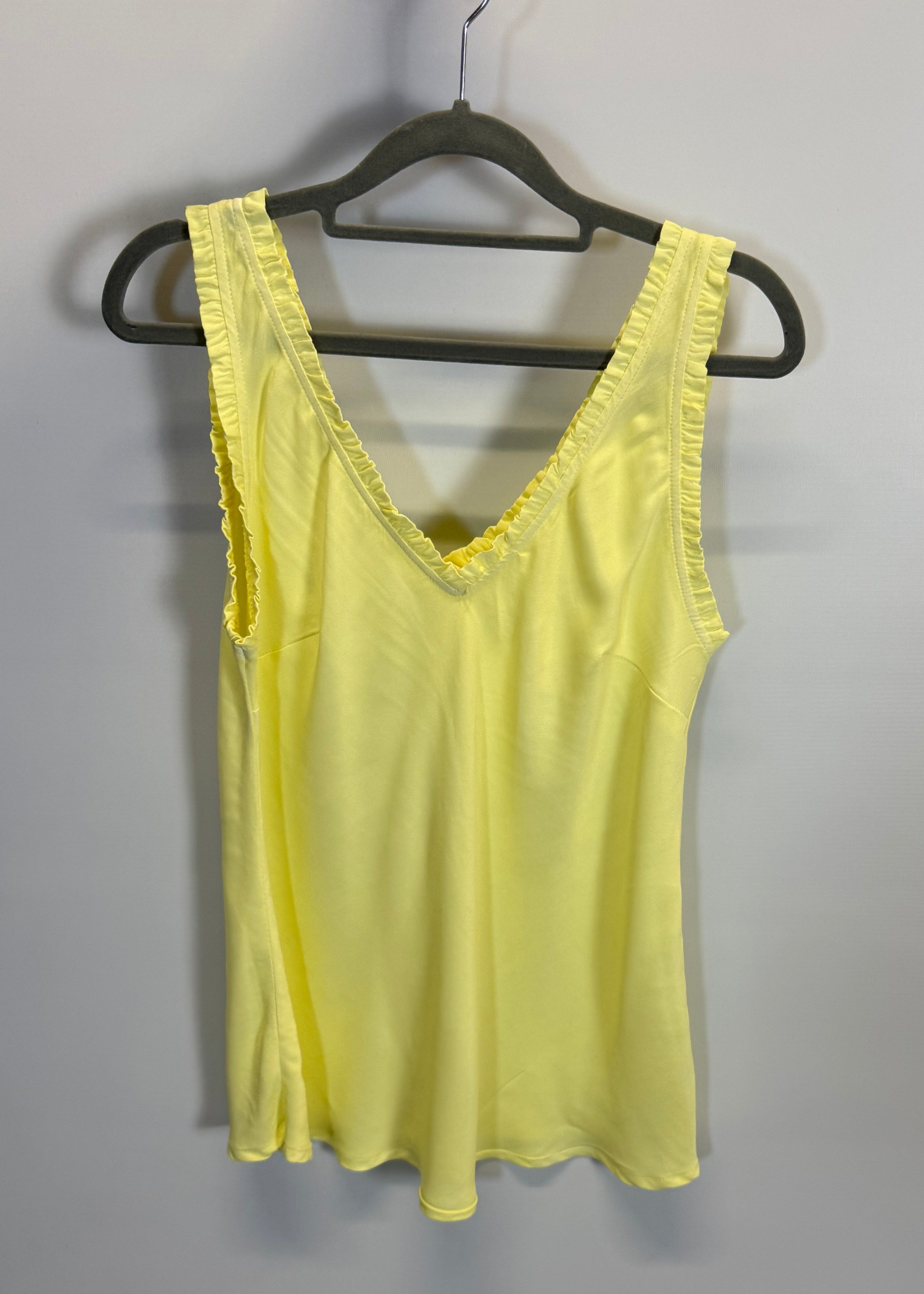 Yellow dress on a hanger against a plain background