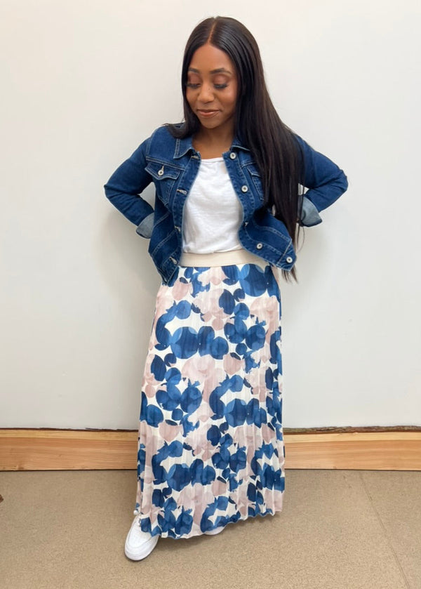 Patterned blue skirt paired with denim jacket in a casual style perfect for summer days or an evening out.