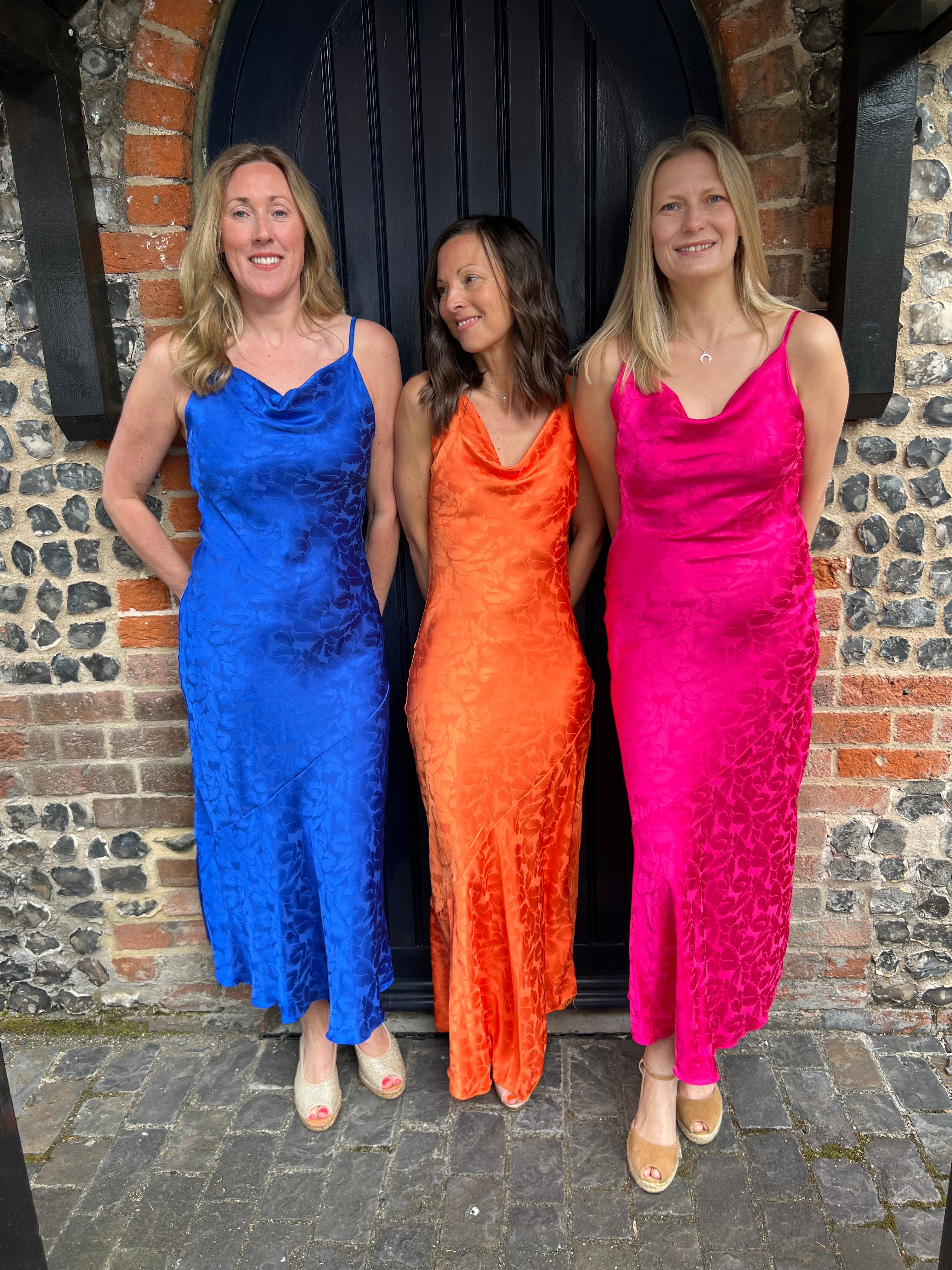 Vibrant summer dresses in royal blue, fuschia pink and orange. With dainty straps and a subtle flower pattern.