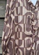 Brown and beige patterned fabric draped over a wooden surface