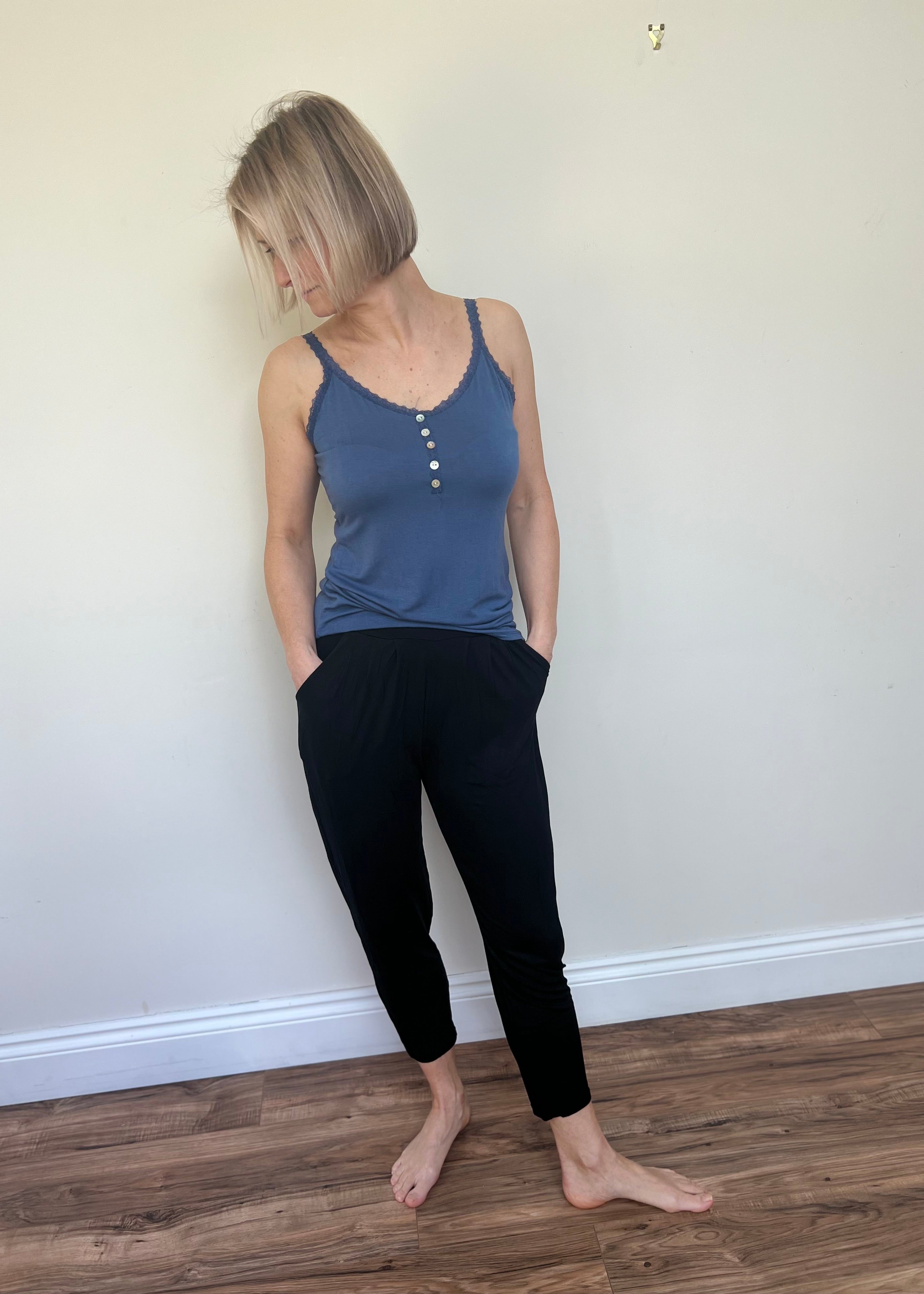 Person standing against a white background wearing a blue strati vest